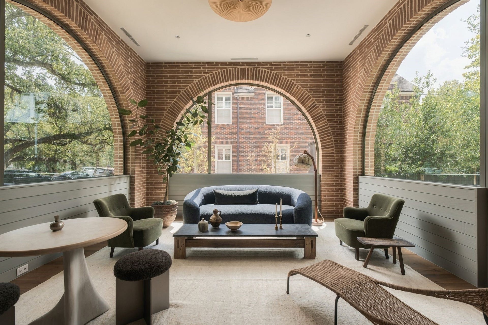 Breathtaking, light-filled parlour wrapped on three sides by arched custom steel windows overlooking both the front & back yards. Mid-Century elongated brick & Accoya wood detailing bring the exterior palette indoors, while a custom steel door opens directly to the backyardarchitecture & landscape beautifully intertwined.