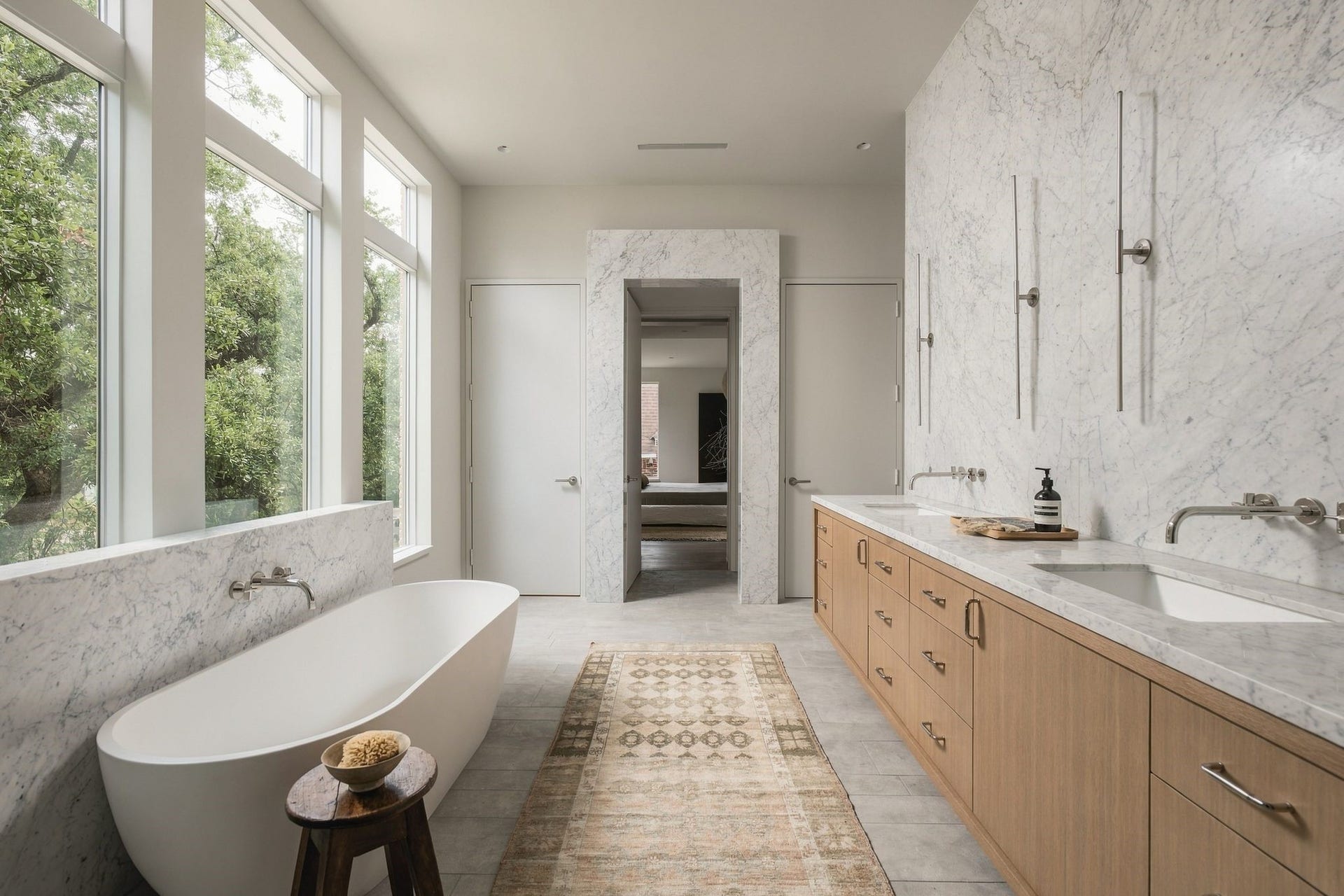 Beautiful from every angle, the primary bath pairs polished Venatino marble w/warm rift white oak cabinetry & refined polished nickel details. A dedicated linen closet provides additional storage, while the marble-cased opening creates an elegant transition back into the primary suite.