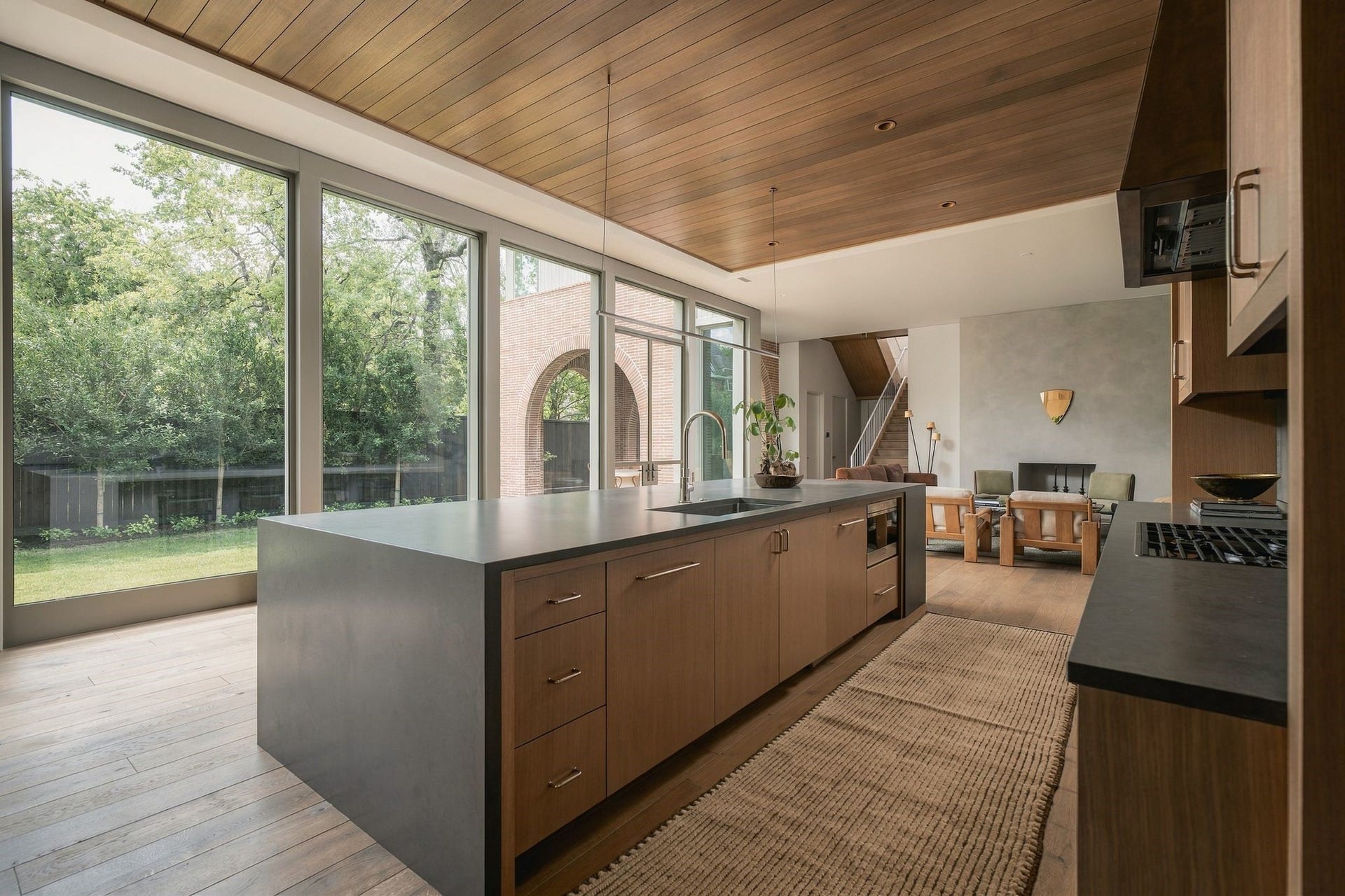 Exceptional details define the kitchen, from the integrated Wolf gas cooktop & custom stainless vent hood surround to polished nickel hardware & expansive island w/single-basin sink. Sub-Zero refrigeration & panel-front Bosch dishwasher are seamlessly integrated into the custom rift white oak cabinetry.