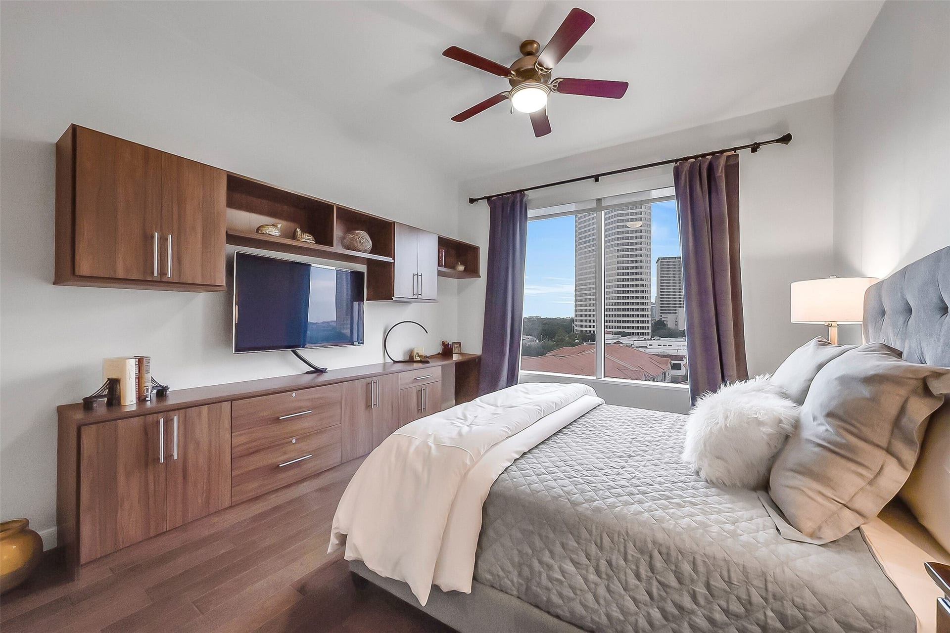 3333 Allen Parkway, #710, Houston, TX 77019 The secondary bedroom features bespoke built-in cabinetry. Blending in with the color of the hardwood floor they create a calming ambiance.