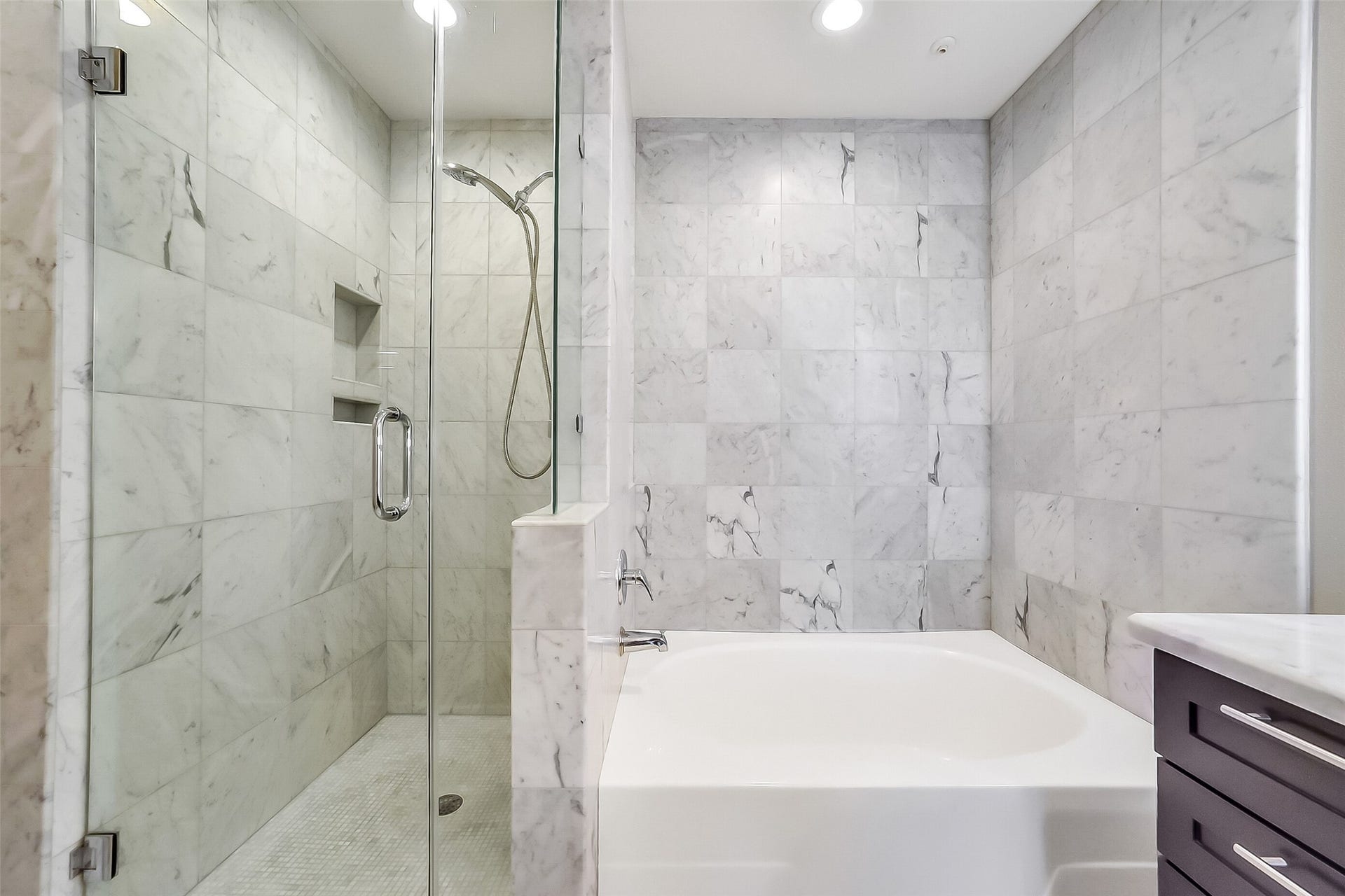 3333 Allen Parkway, #710, Houston, TX 77019 A hand-held shower head and an incorporated niche for your toiletries are thoughtful additions to the shower.