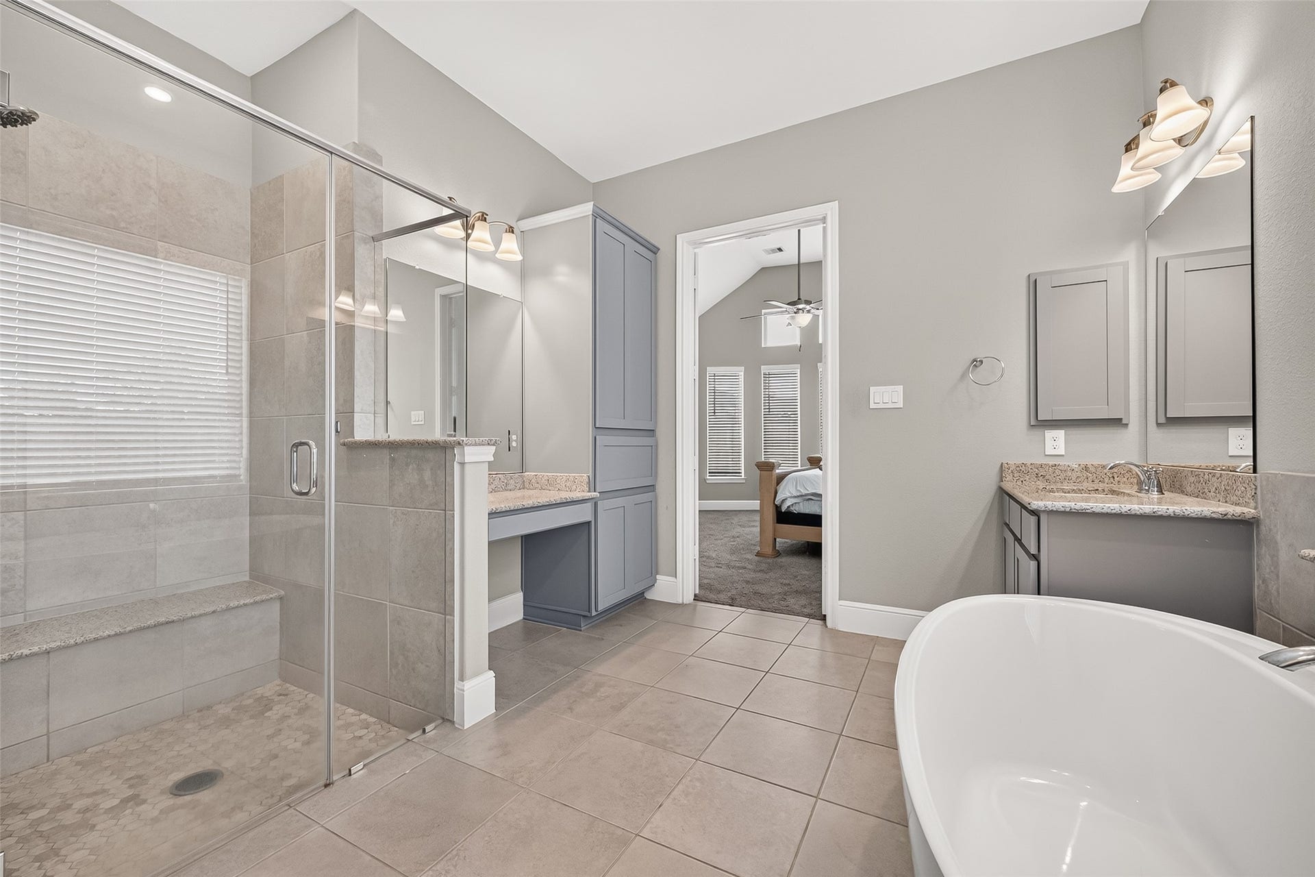 From this view of the primary bath you can see into the bedroom.