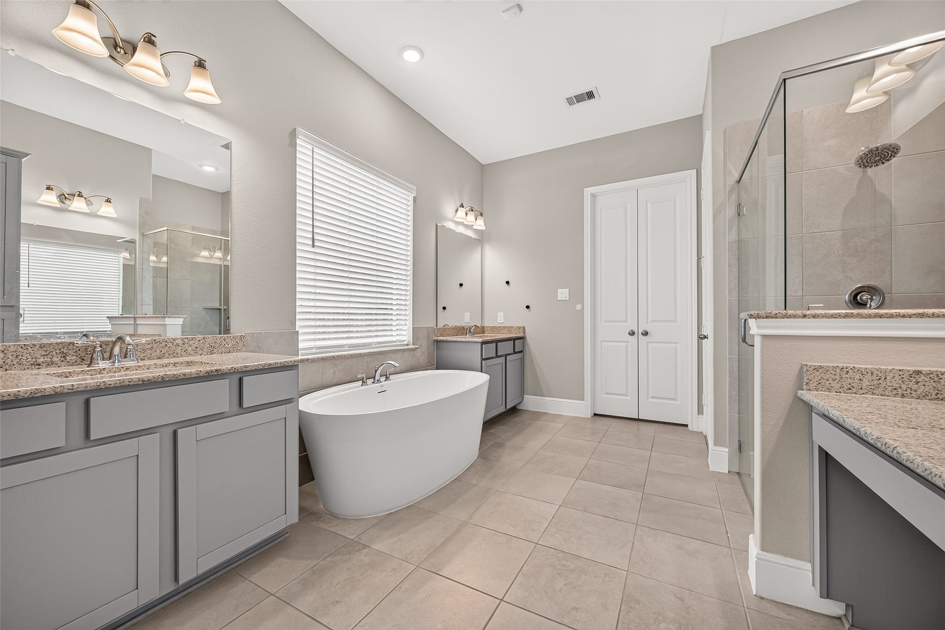 The luxurious primary bath features dual sinks and freestanding soaking tub.