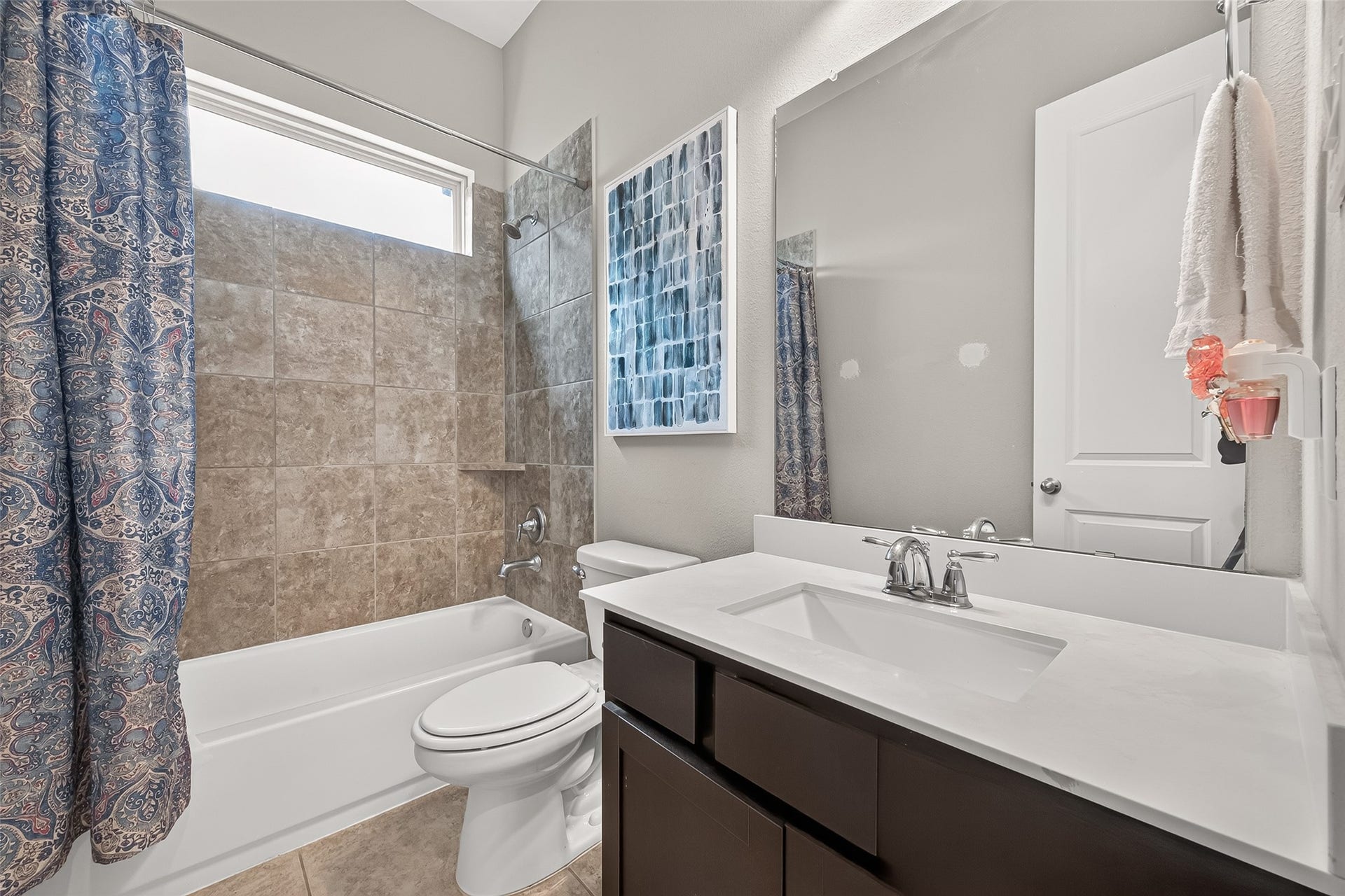 Full bath with tub/shower combination.