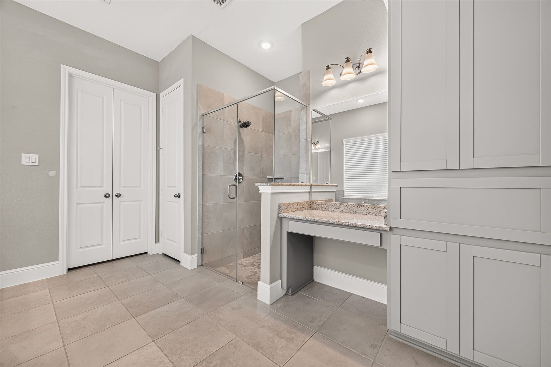 Primary also features walk-in shower and vanity space.