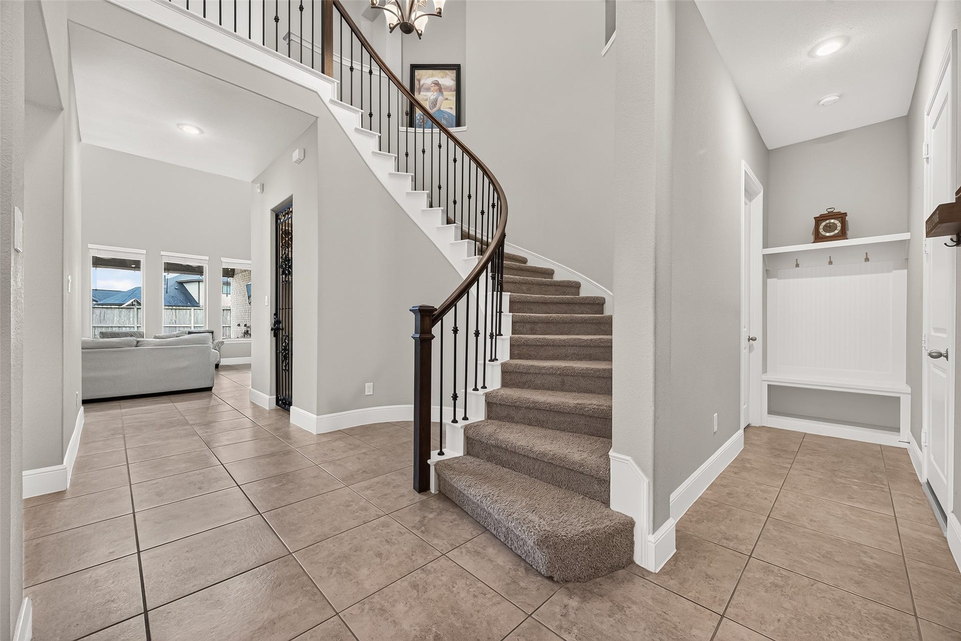 Grand entrance and staircase welcomes you home. To the right is the attached two car garage, conveniently located mud room & one of the guest rooms with an en-suite bath.
