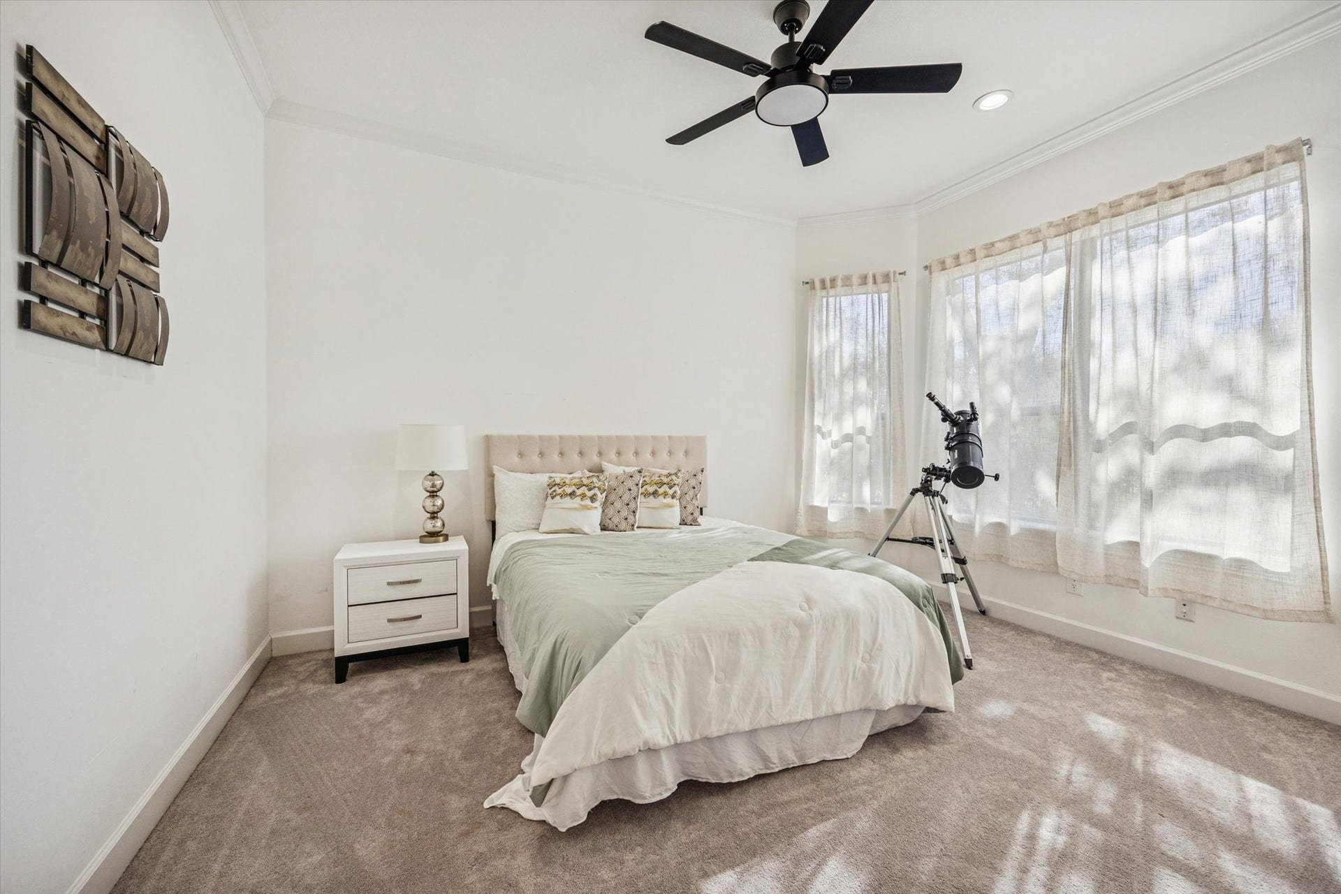 61 Open Sands Court, Sugar Land, TX 77479 Bright and cozy 2nd bedroom downstairs with plush carpeting and large windows that let in ample natural light.