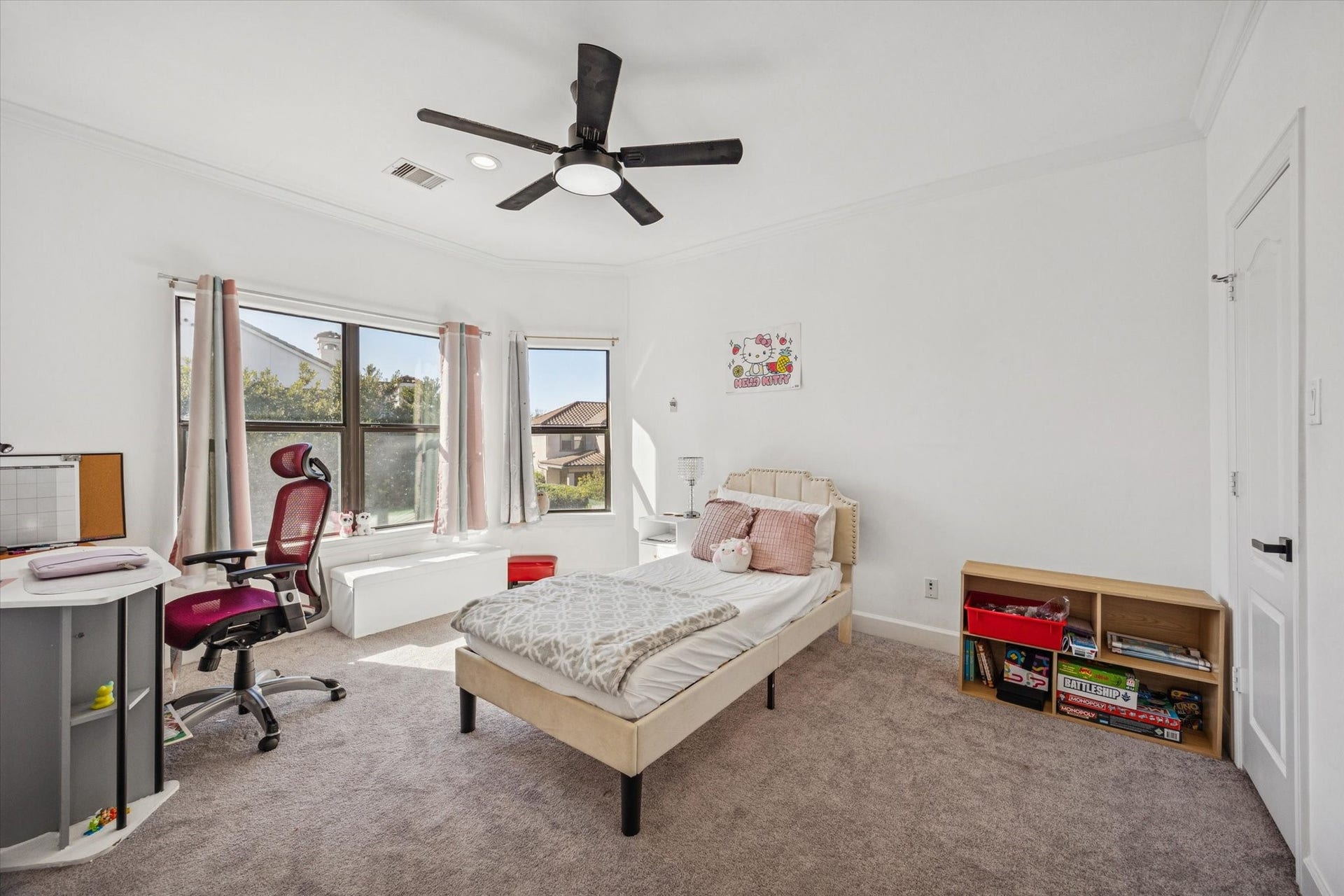 61 Open Sands Court, Sugar Land, TX 77479 Bright and airy upstairs bedroom with carpeted flooring, a ceiling fan, and large windows offering ample natural light.