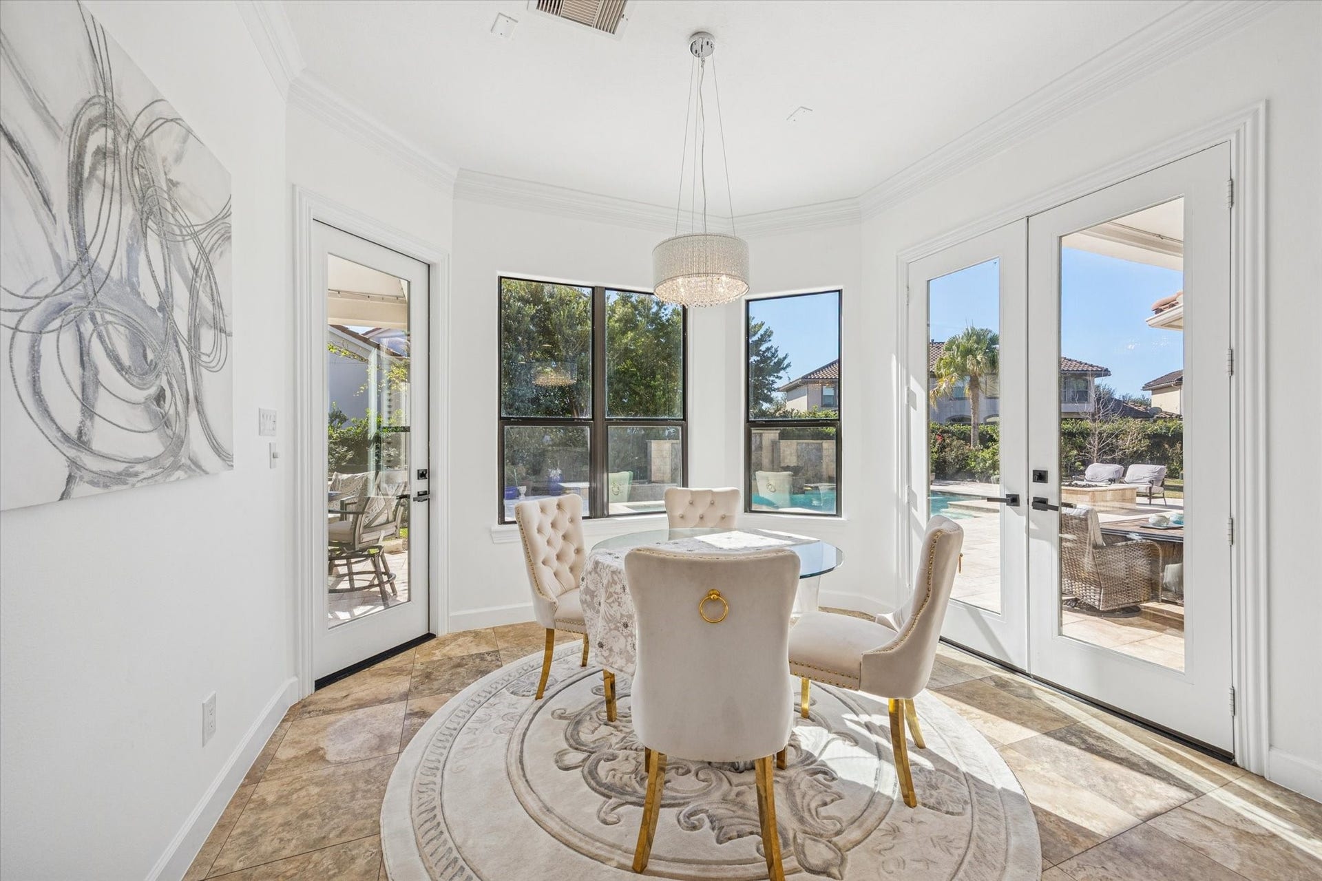 61 Open Sands Court, Sugar Land, TX 77479 This bright breakfast area features large windows and glass door offer abundant natural light and views of a pool and patio, creating an inviting indoor-outdoor living experience.