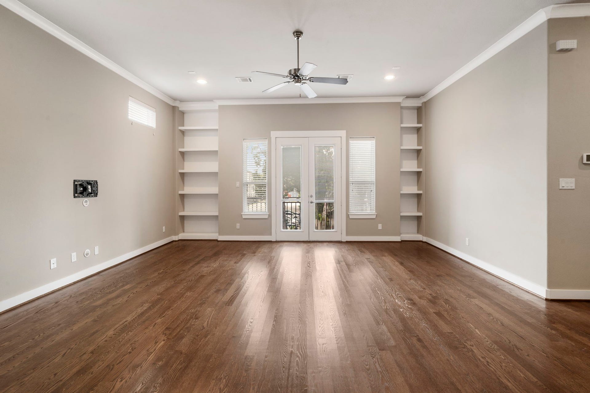 1629 W 23rd Street, Houston, TX 77008 Open and airy living room featuring high ceilings, recessed LED lighting, and French doors that open to an exterior balcony.