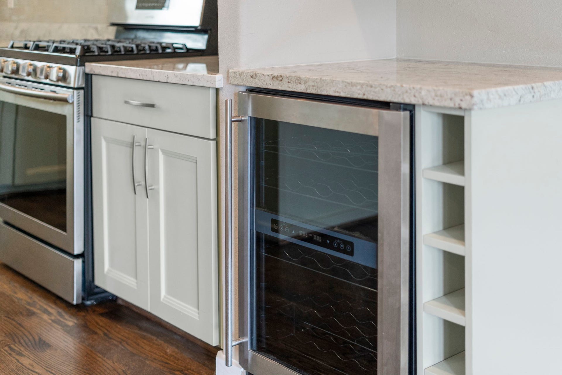 1629 W 23rd Street, Houston, TX 77008 A Magic Chef beverage cooler with a dedicated counter space creates a bar area for entertaining, offering a stylish and functional spot to serve drinks and gather with guests.