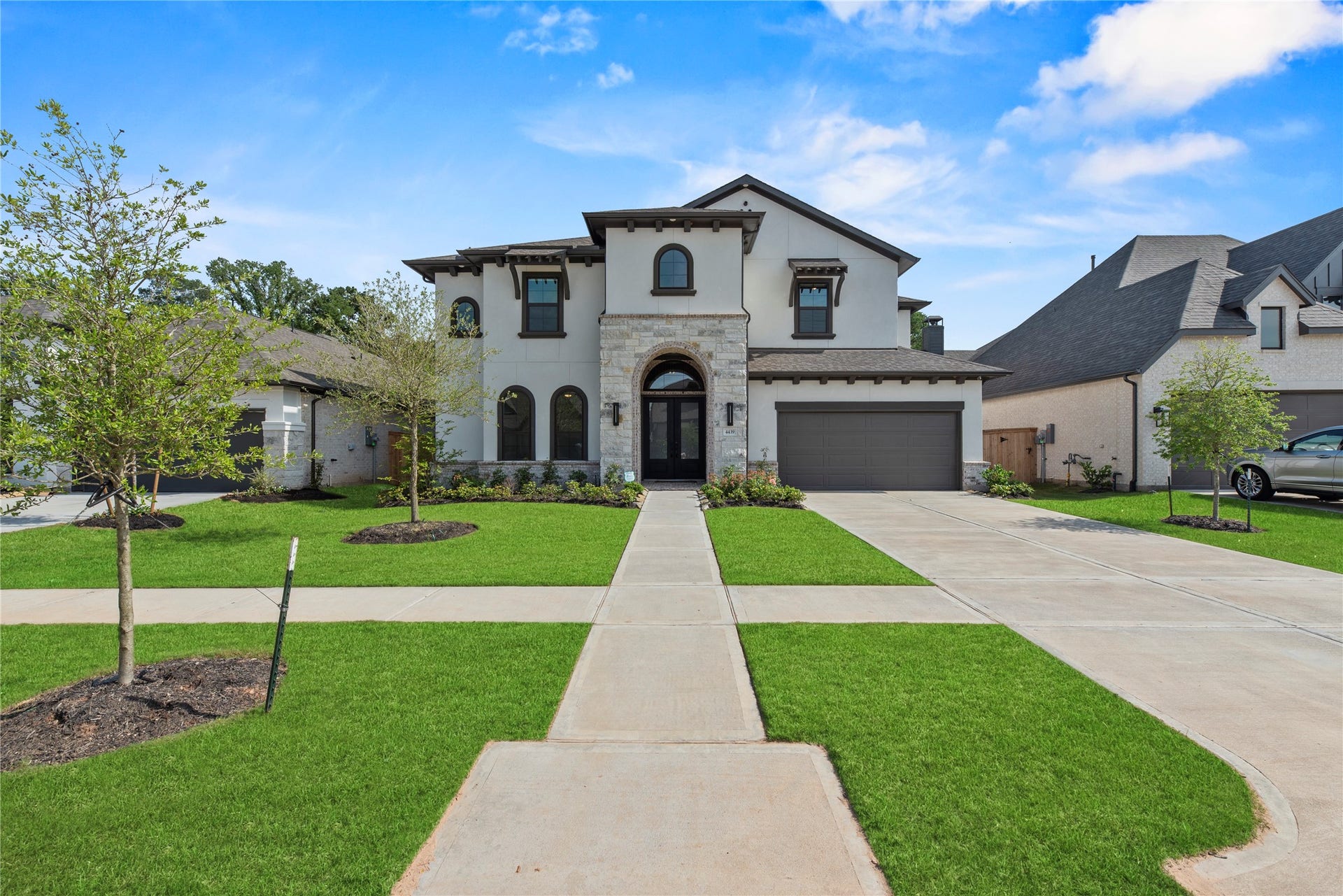 4439 Southpoint Way, Fulshear, TX 77441 The long, doublewide driveway leads to a 3 car, tandem garage with a professionally applied epoxy floor.