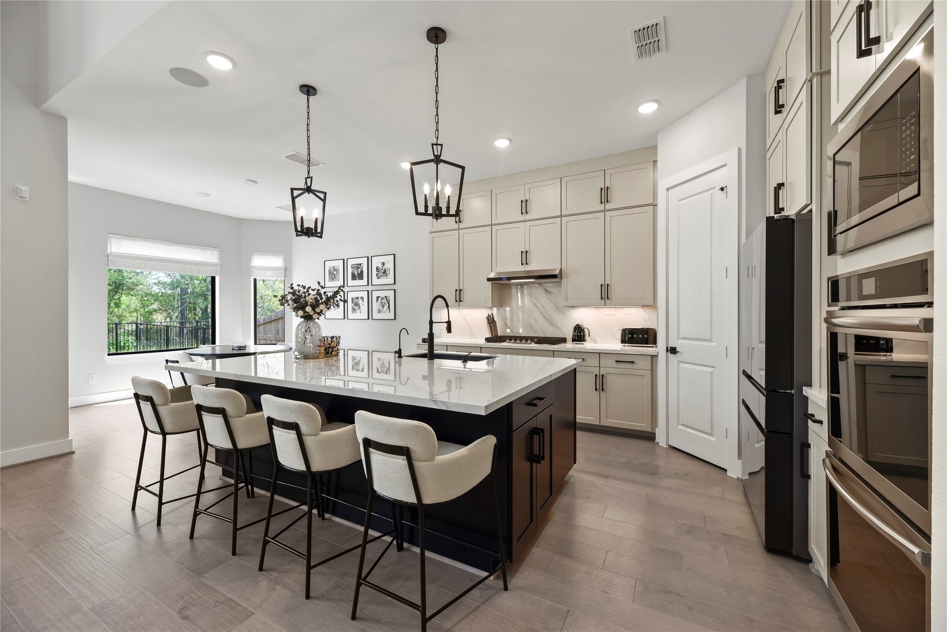 4439 Southpoint Way, Fulshear, TX 77441 The gorgeous kitchen features a huge island with quarts countertops and pendant lighting.