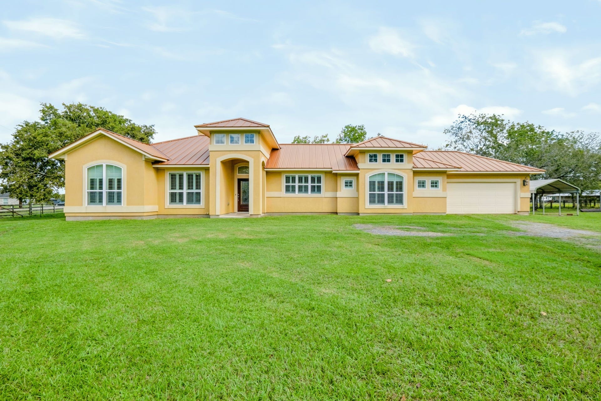 1642 Pultar Road, Richmond, TX 77469 Vibrant single story stucco home with metal roof and 2-car garage on 5.7+ acres in Richmond, close to the historic downtown area.