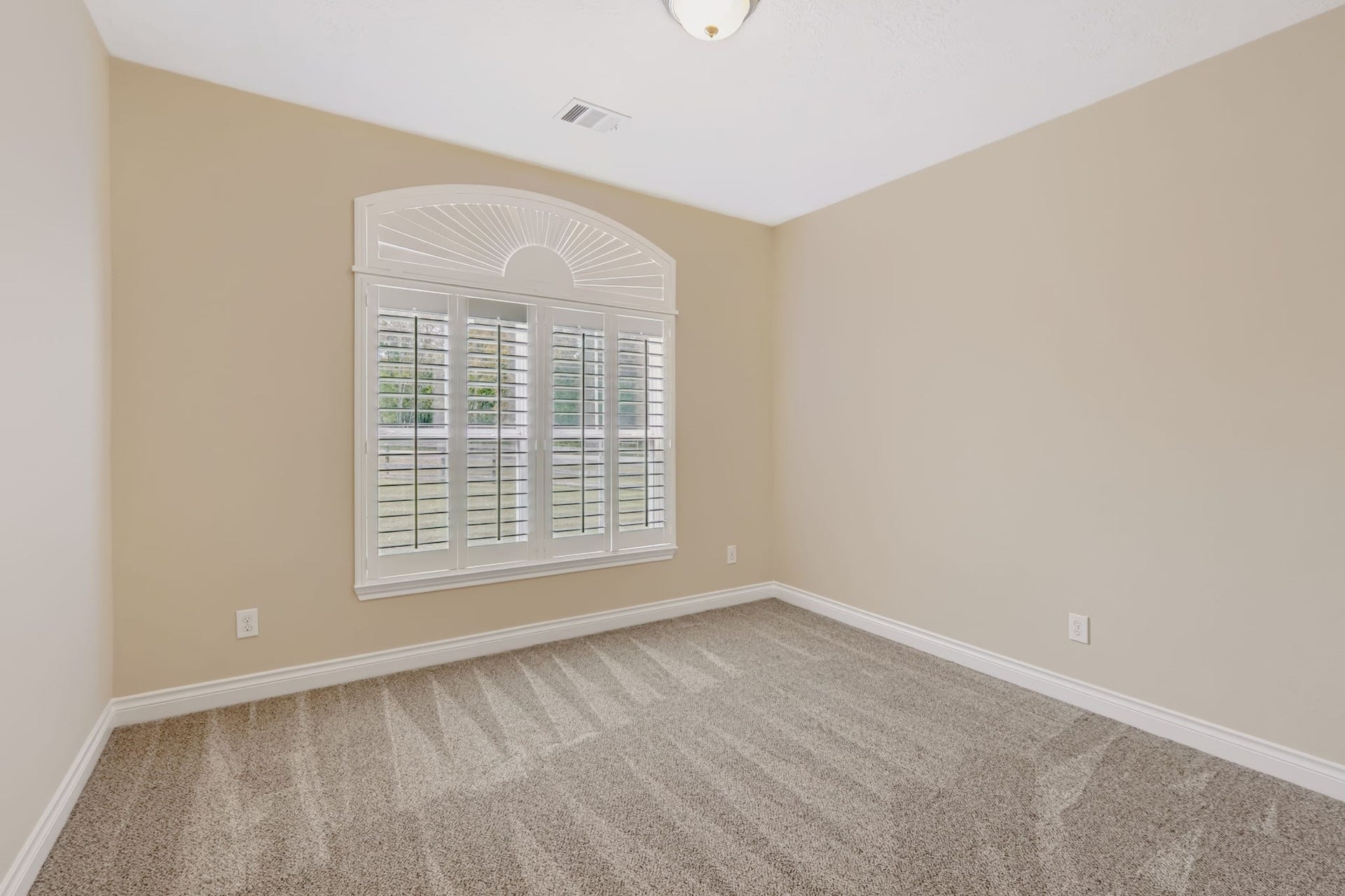 1642 Pultar Road, Richmond, TX 77469 Secondary bedroom at the front of the home with shutters and new carpet.