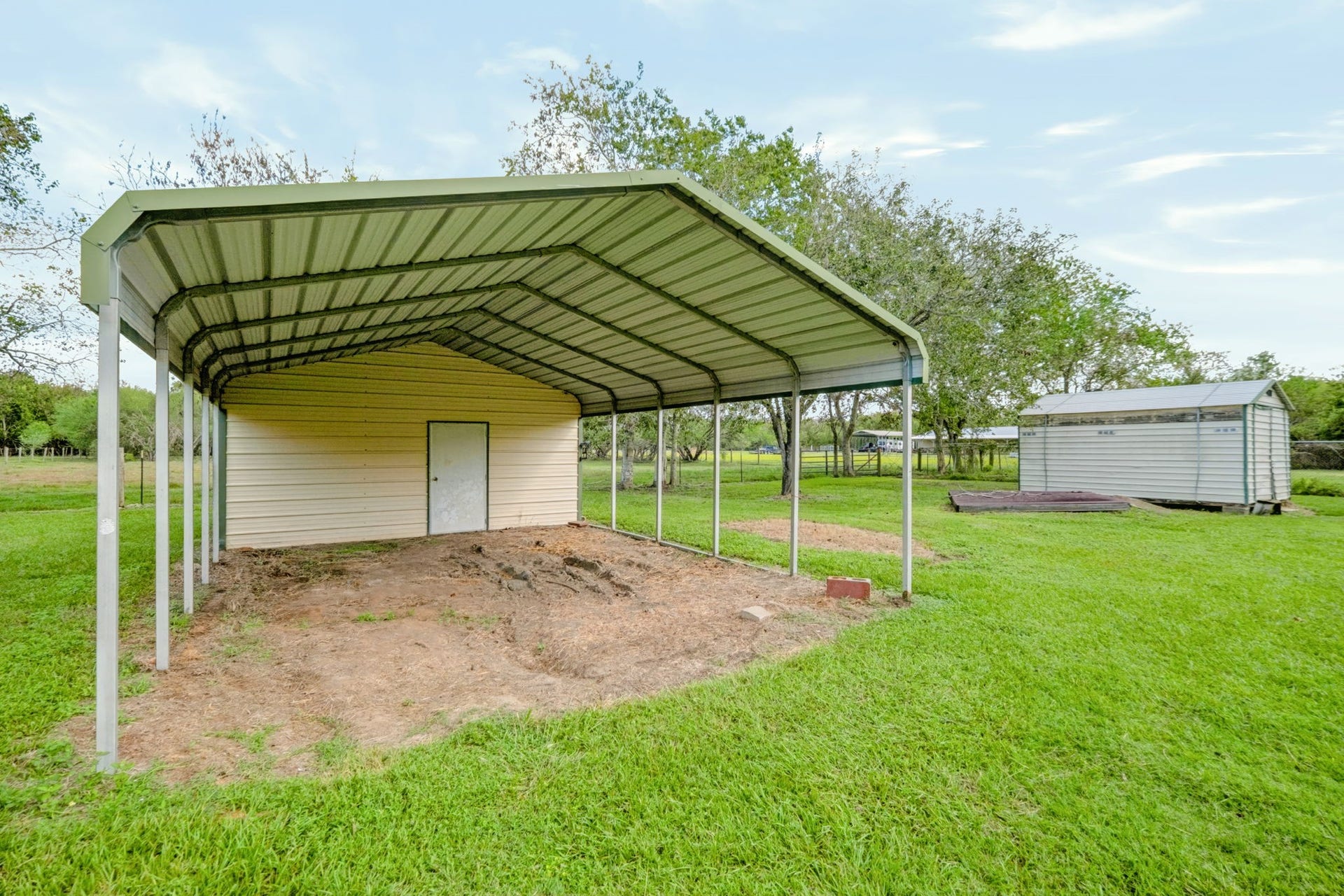 1642 Pultar Road, Richmond, TX 77469 To the right of the house is this 18'x36' metal carport with tons of extra storage through the door.