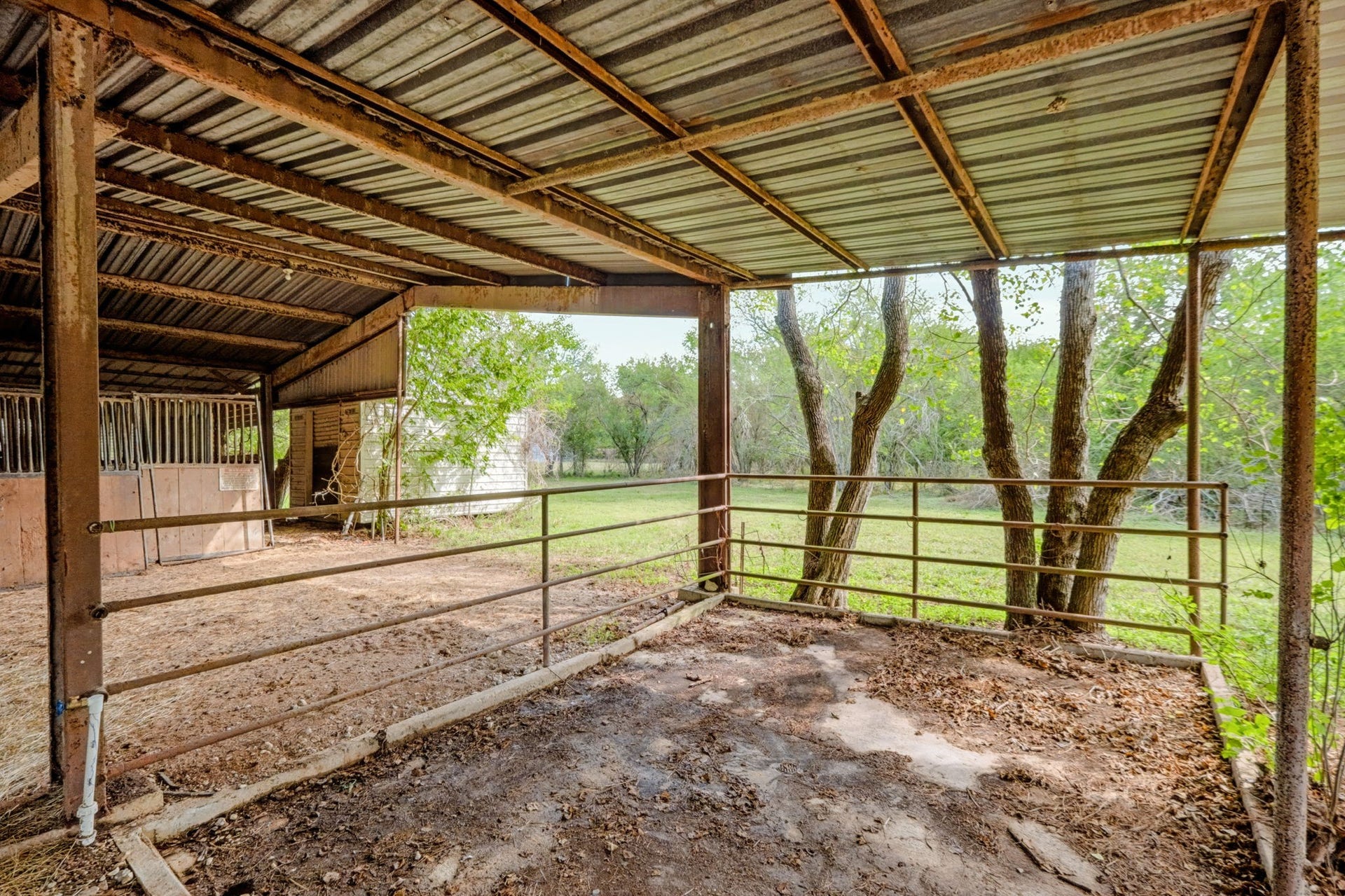 1642 Pultar Road, Richmond, TX 77469 Covered concrete wash rack. Behind the barn is Morgan storage shed, currently being used as a hay room.