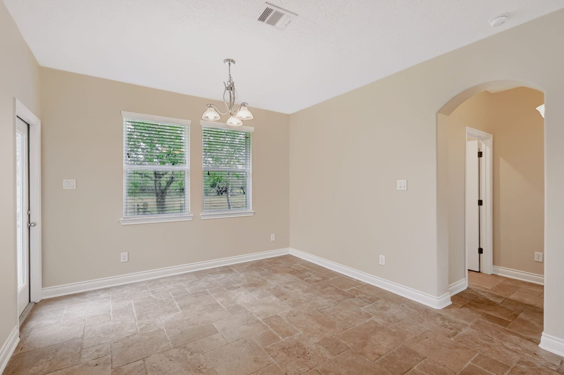 1642 Pultar Road, Richmond, TX 77469 Breakfast room has a door to the back yard. The utility room and primary bedroom is through the arched opening on the right.