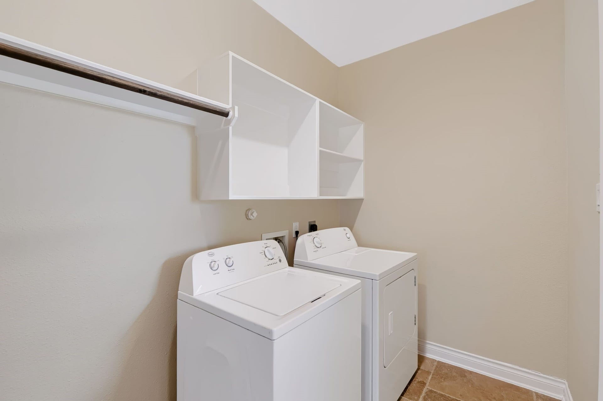 1642 Pultar Road, Richmond, TX 77469 Laundry room with storage shelving and space to hang dry clothes. The garage is accessible through the back door in the laundry room. Washer and dryer are included with the house.