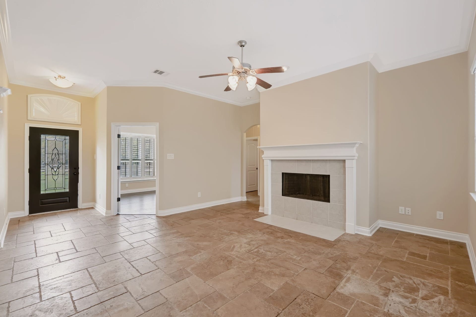 1642 Pultar Road, Richmond, TX 77469 Open floor plan with study to the left of the front door and family room with wood burning fireplace and ceiling fan in the center of the home.