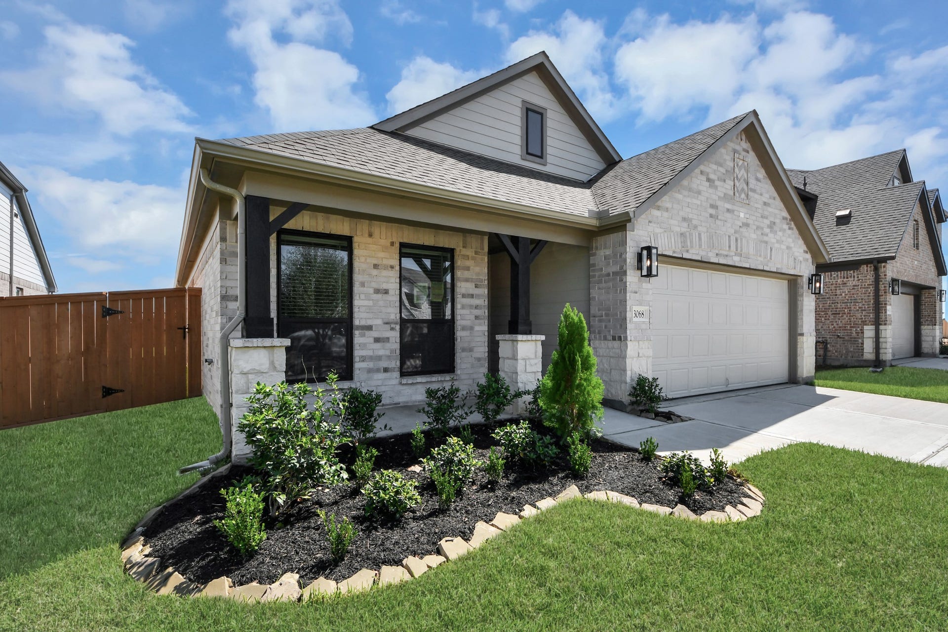 3068 Spoolwood Trail, Magnolia, TX 77355 The residence features a practical 2-car garage complemented by a generous driveway, ensuring abundant space for parking needs.