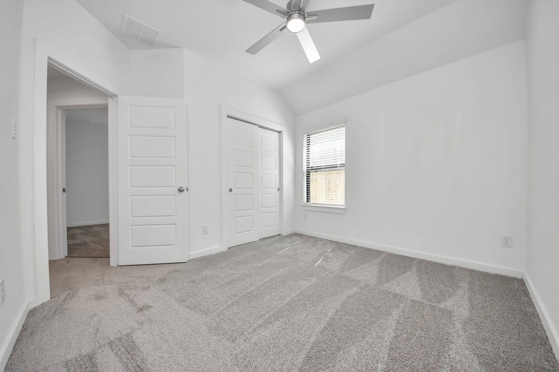 3068 Spoolwood Trail, Magnolia, TX 77355 Generously sized secondary bedrooms featuring spacious closets, soft and inviting carpeting underfoot, large windows allowing plenty of natural light, and the added touch of privacy blinds for your personal retreat.