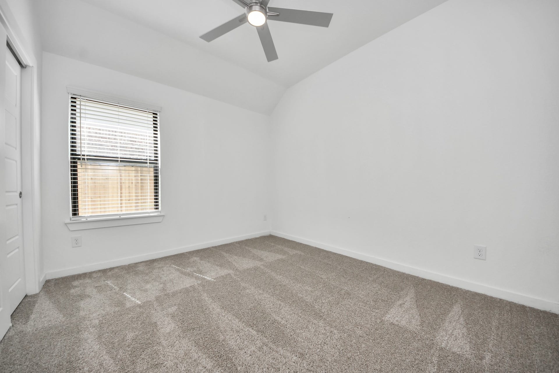 3068 Spoolwood Trail, Magnolia, TX 77355 Secondary bedroom features plush carpeting, large windows that let in plenty of natural light, bright paint, and spacious closets.