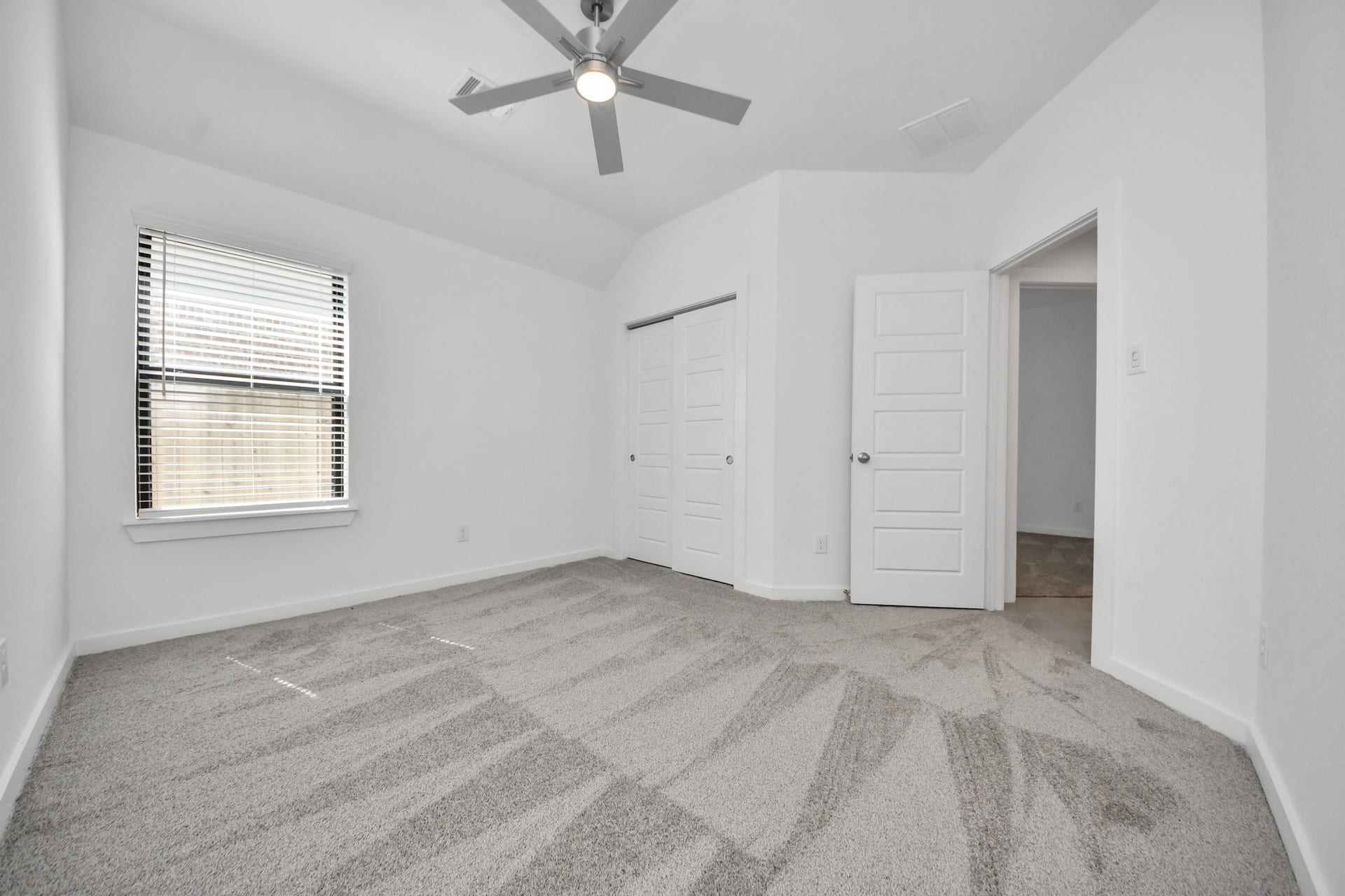 3068 Spoolwood Trail, Magnolia, TX 77355 Generously sized secondary bedrooms featuring spacious closets, soft and inviting carpeting underfoot, large windows allowing plenty of natural light, and the added touch of privacy blinds for your personal retreat.