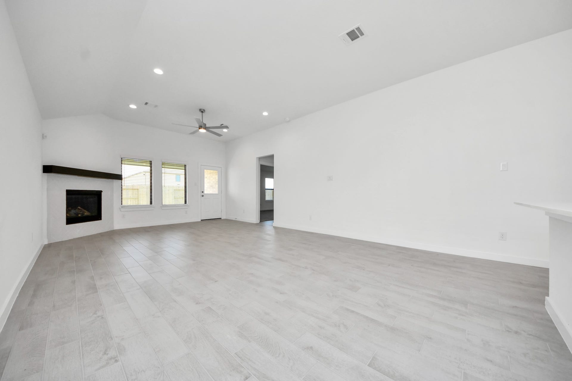 3068 Spoolwood Trail, Magnolia, TX 77355 Bring your loved ones and guests together in the inviting living room! Boasting lofty high ceilings, recessed lighting, a stylish ceiling fan, custom paint, stunning flooring, and expansive windows that flood the space with ample natural light all day long.