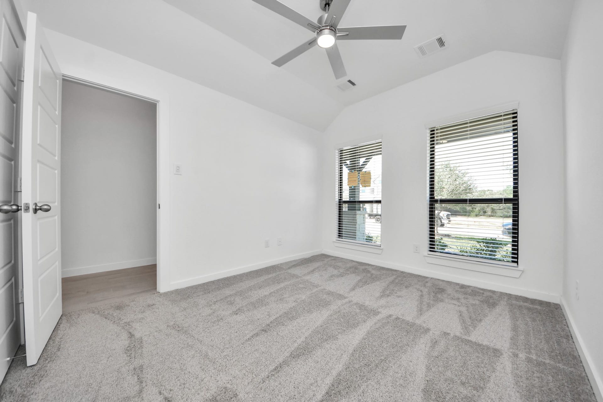 3068 Spoolwood Trail, Magnolia, TX 77355 Generously sized secondary bedrooms featuring spacious closets, soft and inviting carpeting underfoot, large windows allowing plenty of natural light, and the added touch of privacy blinds for your personal retreat.