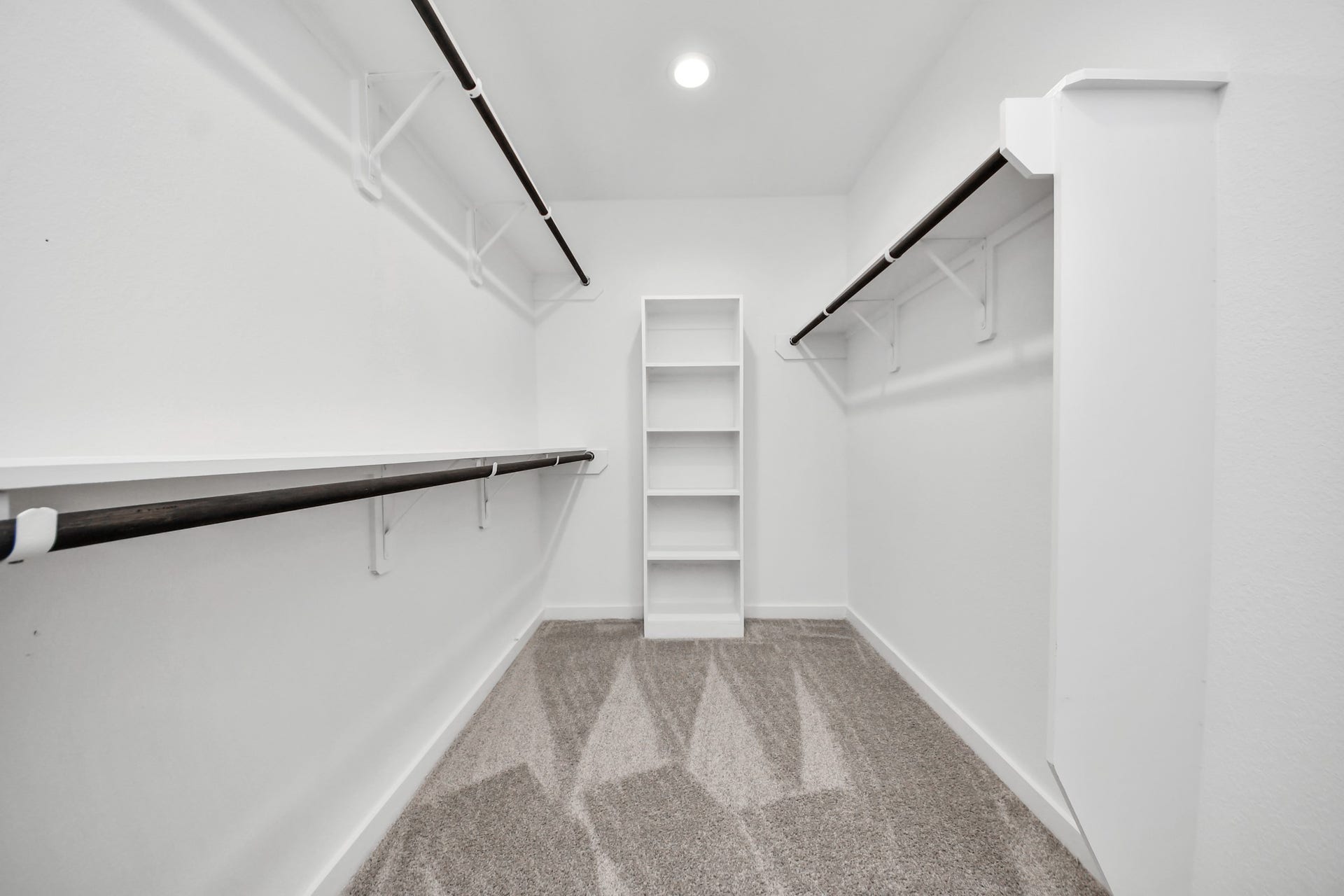 3068 Spoolwood Trail, Magnolia, TX 77355 Walk-in closet that epitomizes luxury and practicality. This generously sized space features built-in shelving, offering abundant room for impeccable organization. High ceilings and recessed lighting create a bright and welcoming ambiance.