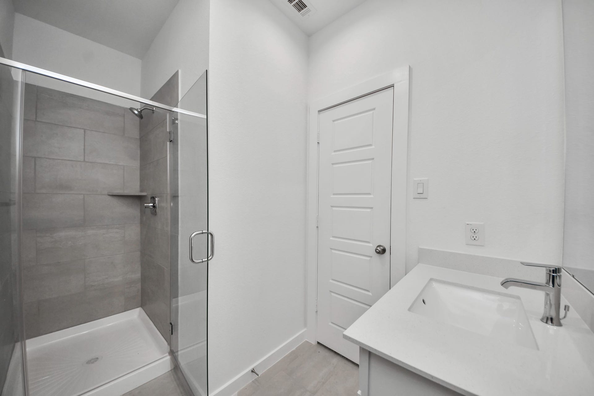 3068 Spoolwood Trail, Magnolia, TX 77355 Secondary bath features tile flooring, walk-in shower with tile surround, light stained wood cabinets, beautiful light countertop.