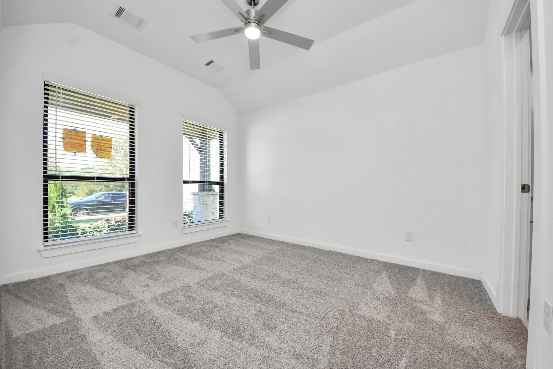 3068 Spoolwood Trail, Magnolia, TX 77355 Secondary bedroom features plush carpeting, large windows that let in plenty of natural light, bright paint, and spacious closets.