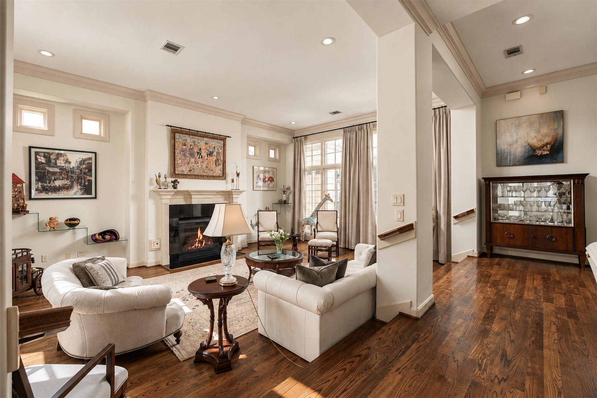 523 Lovett Boulevard, Houston, TX 77006 Arriving on the second floor, the home opens dramatically into its main living spaces, where tall windows, generous ceiling height and a fireplace establish an immediate sense of scale. **Rendering of neutral wall color**