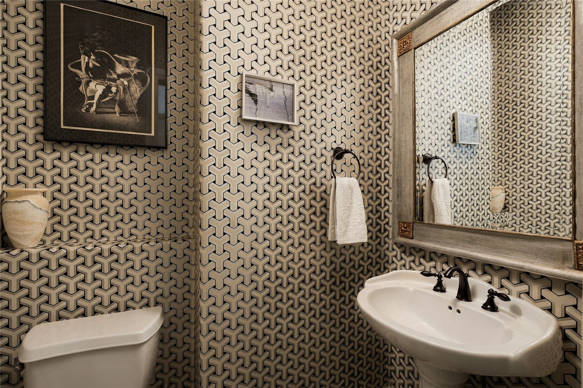 523 Lovett Boulevard, Houston, TX 77006 A little unexpected personality along the way; the powder room trades the homes softer palette for bold geometric wallcovering and dark contrasting fixtures.