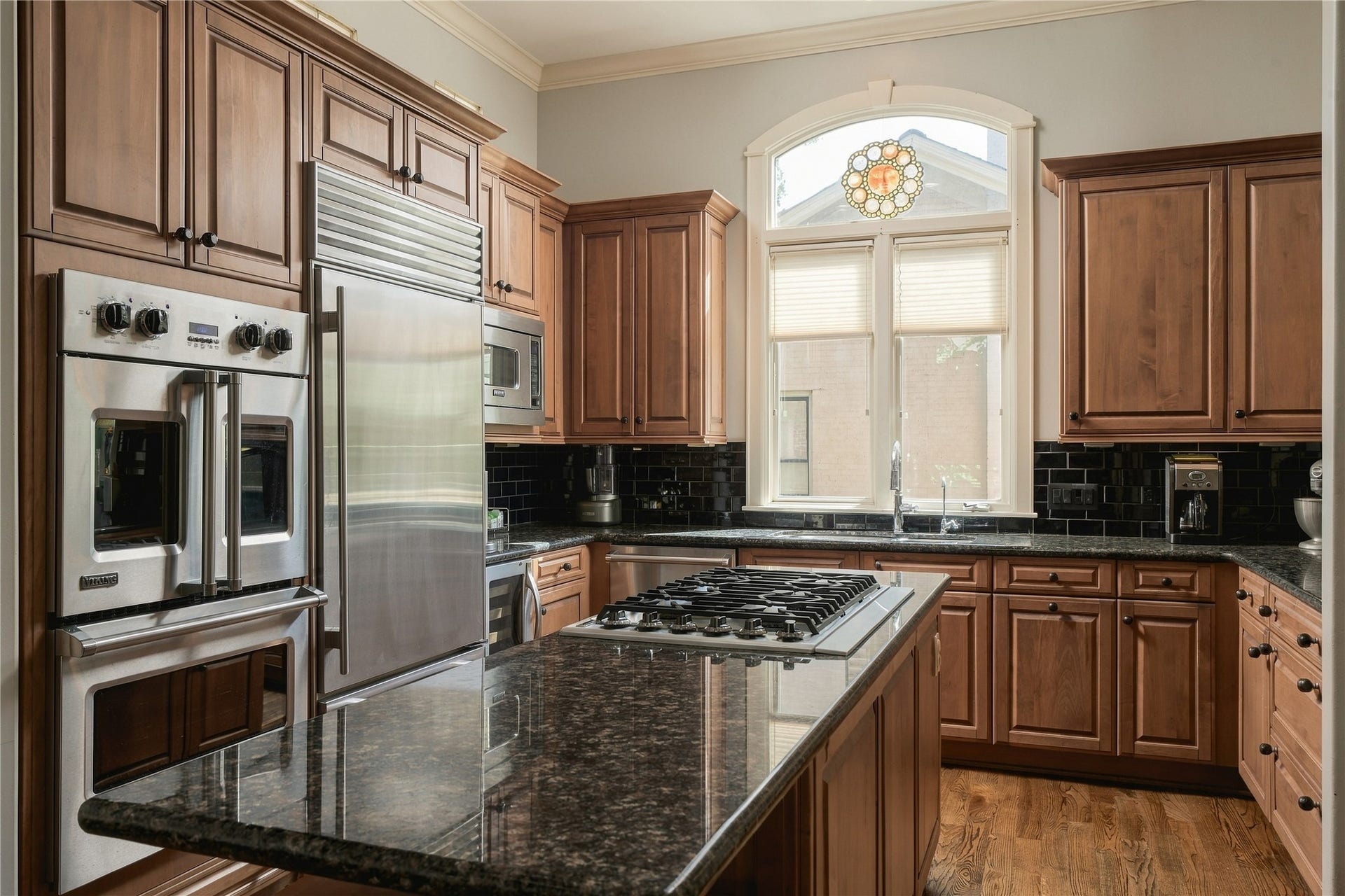 523 Lovett Boulevard, Houston, TX 77006 The appliance wall is anchored by a Viking double French-door oven and Sub-Zero refrigerator, seamlessly integrated into the surrounding cabinetry.