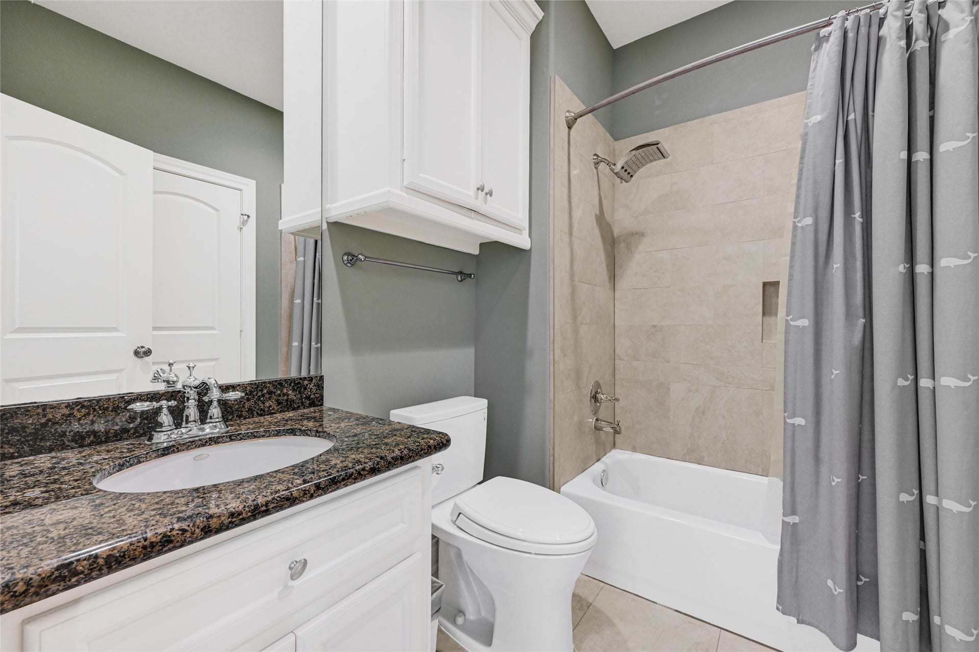 3 Waterford Pointe Circle, Sugar Land, TX 77479 Stylish bathroom featuring elegant granite countertops, sleek white cabinetry, and a modern shower-tub combo with neutral tile accents.