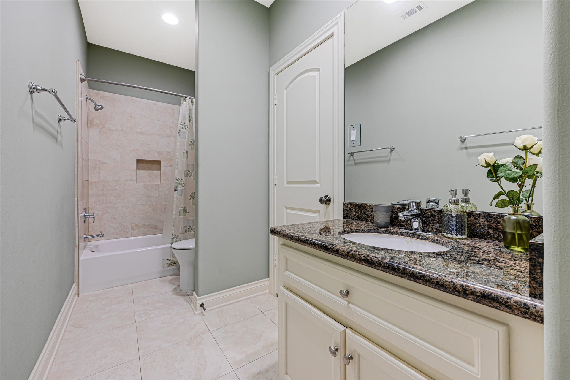 3 Waterford Pointe Circle, Sugar Land, TX 77479 Elegant bathroom featuring a granite countertop, stylish vanity, and a modern shower-tub combination with sleek tilework.