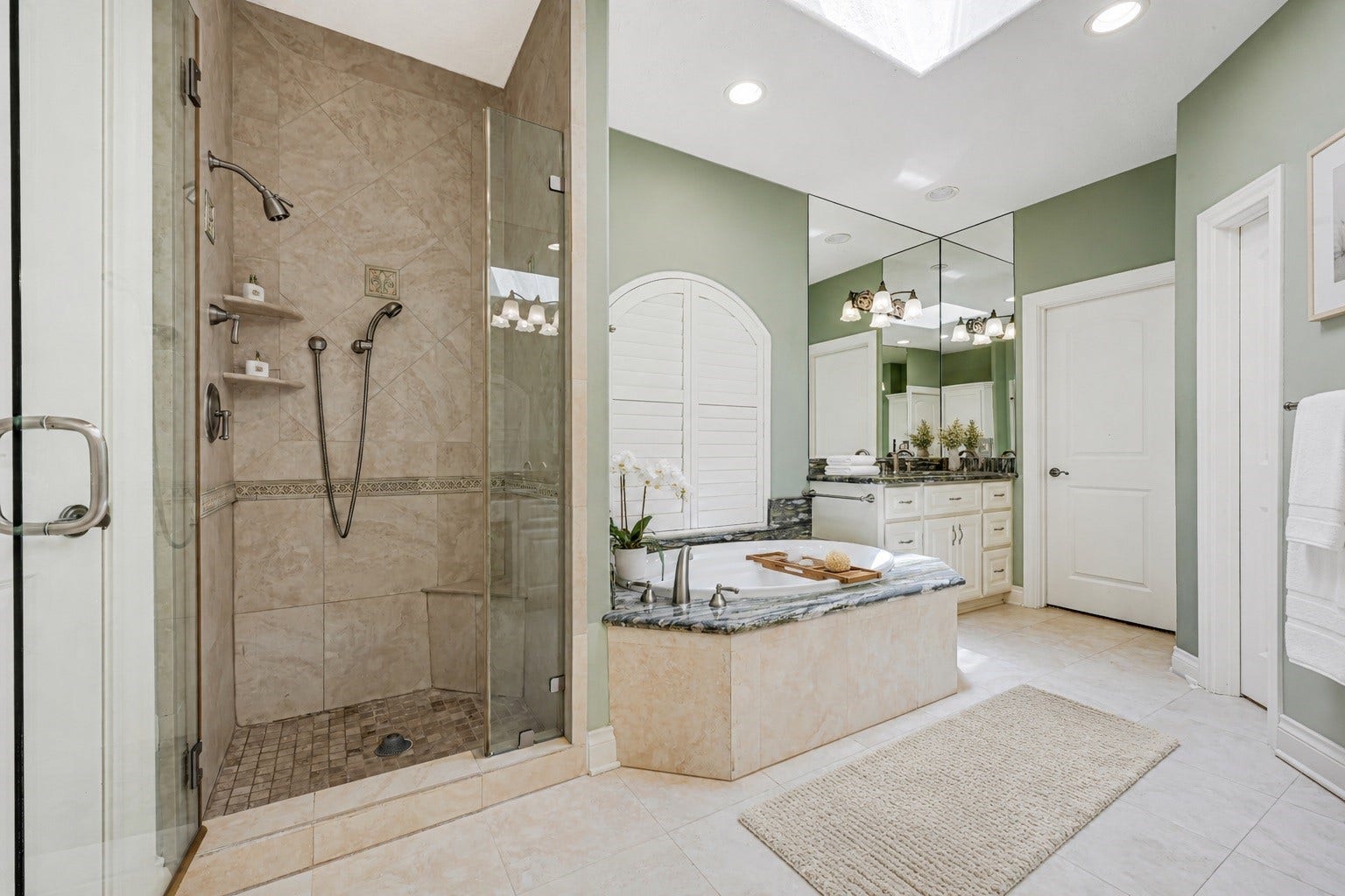 3 Waterford Pointe Circle, Sugar Land, TX 77479 Luxurious bathroom with a spacious glass-enclosed shower, elegant soaking tub, and dual vanity with granite countertops, all enhanced by soft natural lighting.
