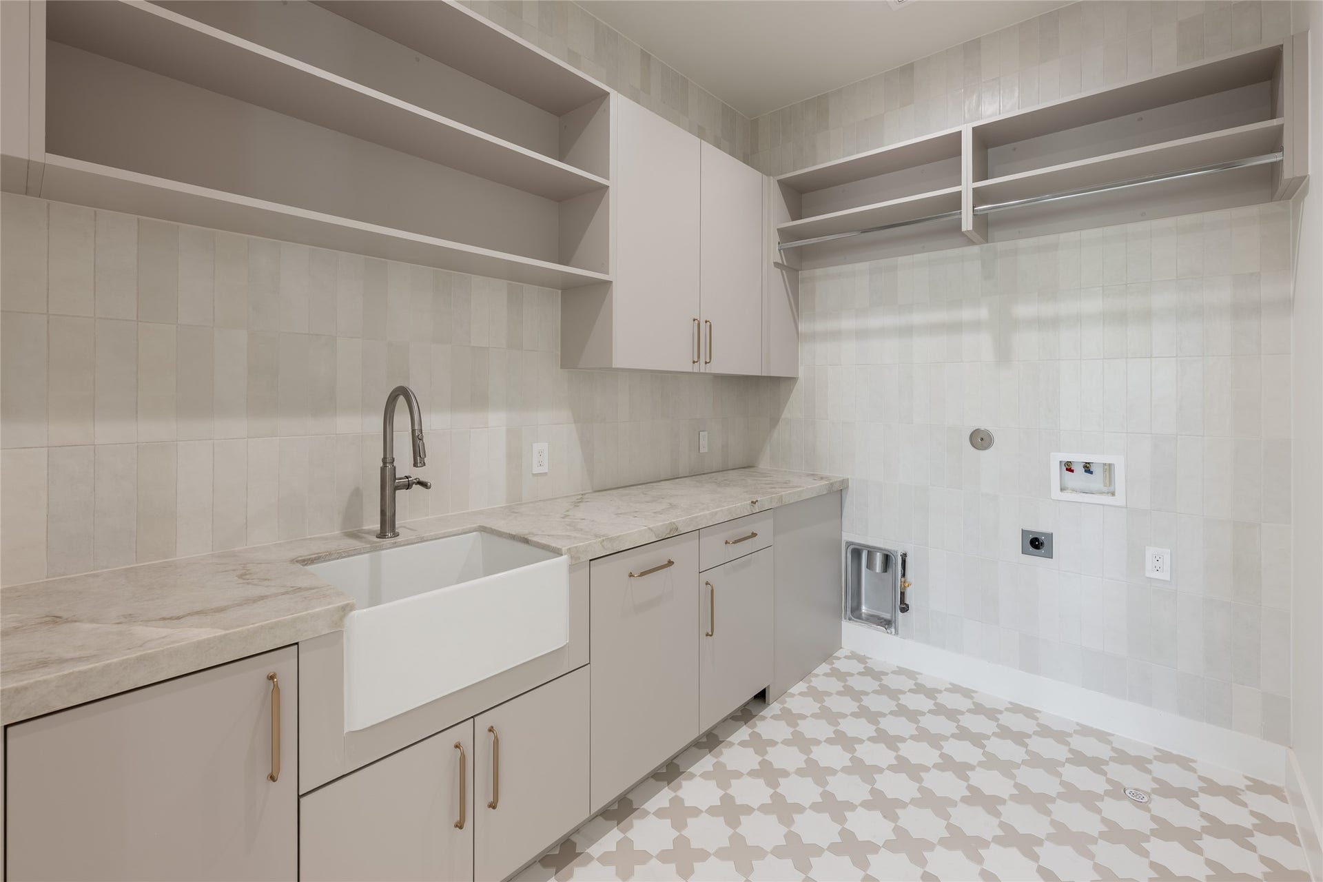 1109 Voight Street, Houston, TX 77009 The utility room pairs generous built in storage with a dedicated sink and expansive counter space, bringing the same attention to function and finish into one of the homes hardest working spaces.