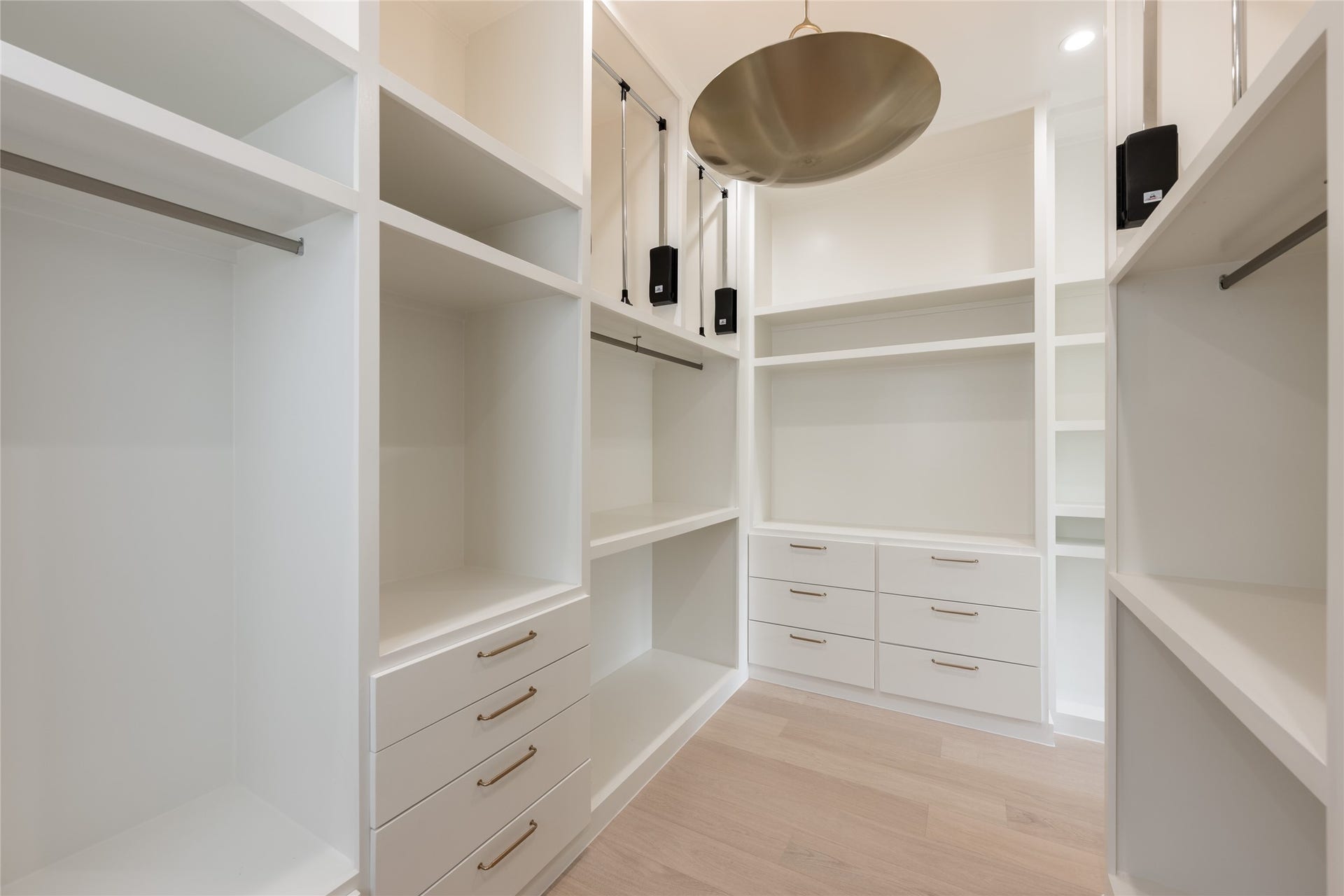 1109 Voight Street, Houston, TX 77009 The expansive primary closet is thoughtfully outfitted with custom built ins, dedicated drawers and abundant hanging space, creating a dressing room experience designed around organization.