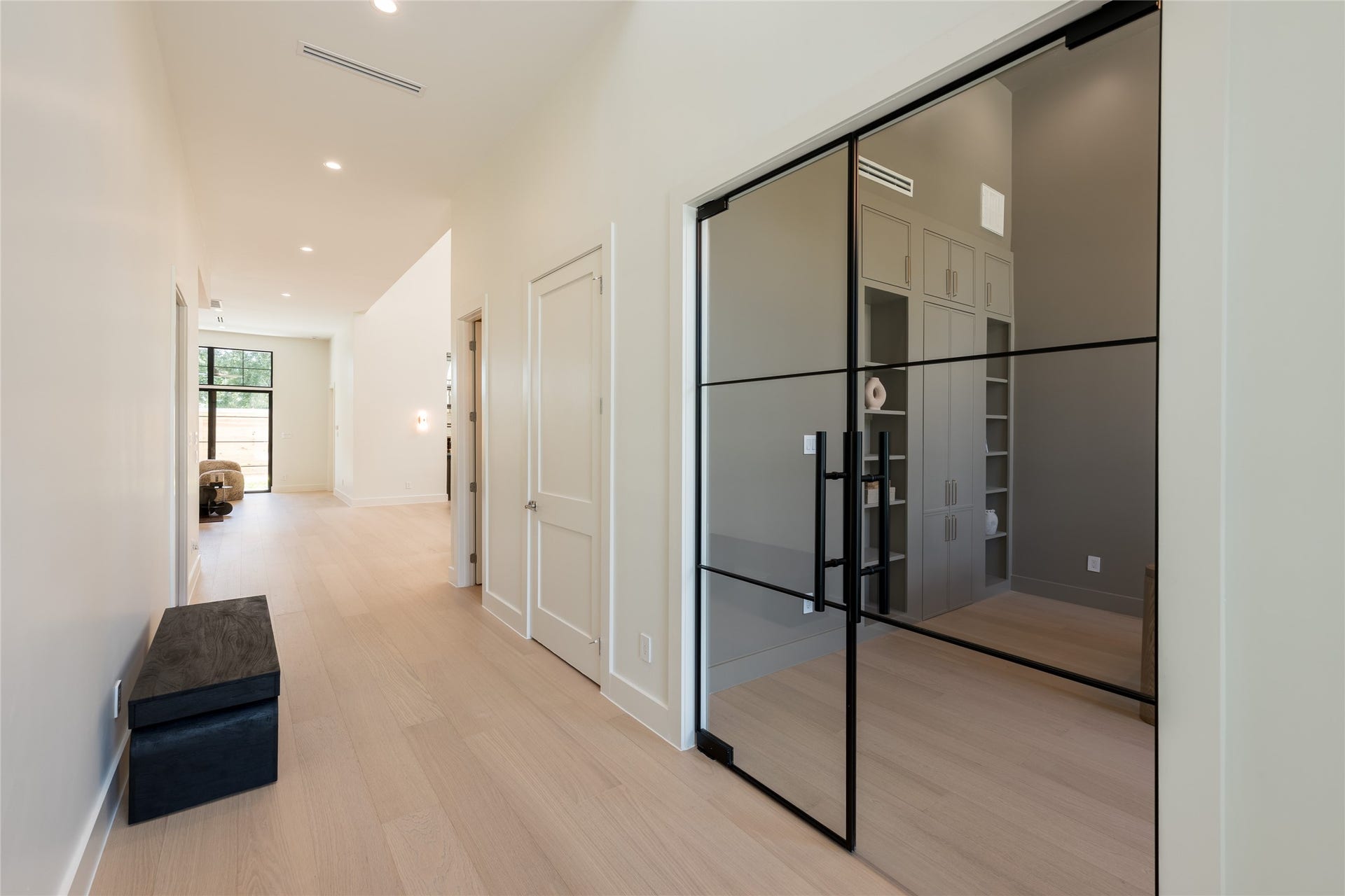 1109 Voight Street, Houston, TX 77009 The foyer offers a striking introduction to the home, with clean sightlines leading toward the private study, where a glass entry adds architectural interest while preserving the openness of the space.