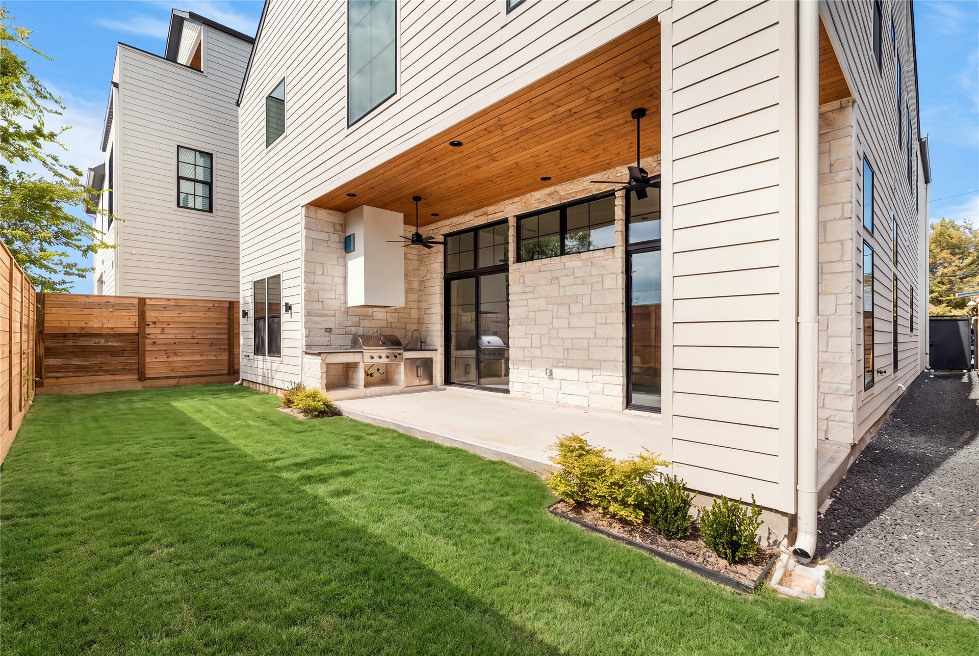 1109 Voight Street, Houston, TX 77009 Extending beyond the covered patio, the backyard offers a welcome sense of openness with a long, uninterrupted lawn framed by privacy fencing. The outdoor kitchen and sheltered seating area establish a natural gathering place, while the surrounding green space provides flexibility for a variety of outdoor activities.