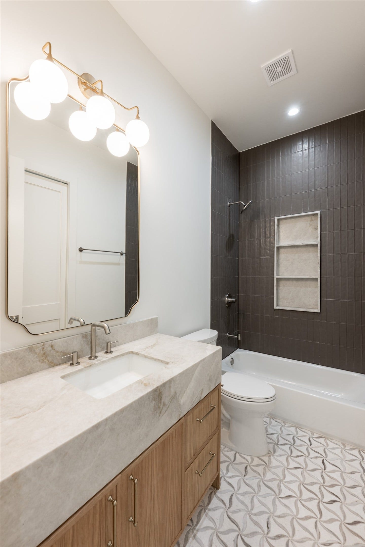 1109 Voight Street, Houston, TX 77009 The mother-in-law suites private bath is finished with natural stone, full height designer tile and a glass enclosed shower, giving the first floor retreat the same level of finish found throughout the home.