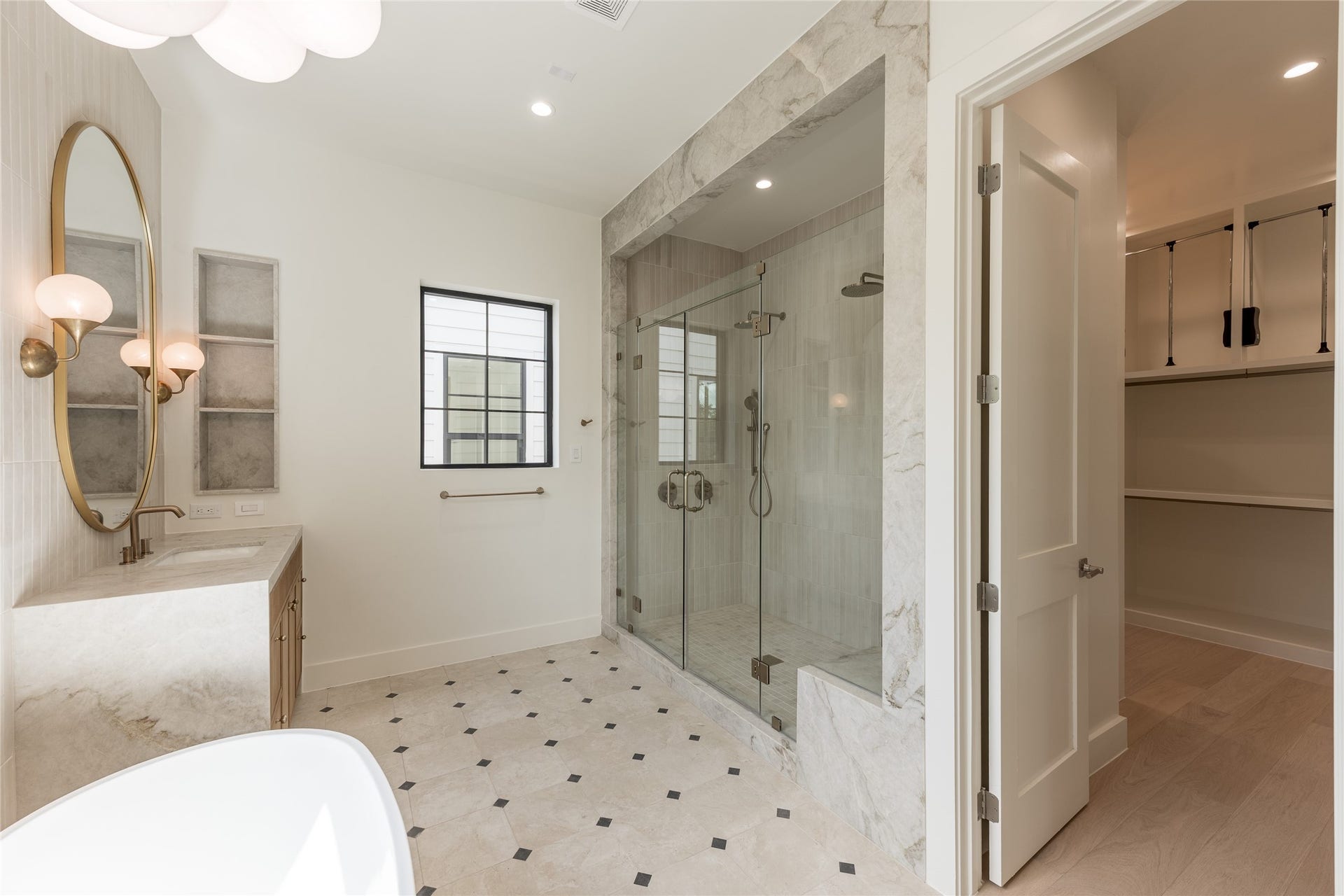 1109 Voight Street, Houston, TX 77009 A seamless transition from the primary bath leads into the generous walk in closet, with custom built in shelving extending the suites thoughtful design into everyday function.