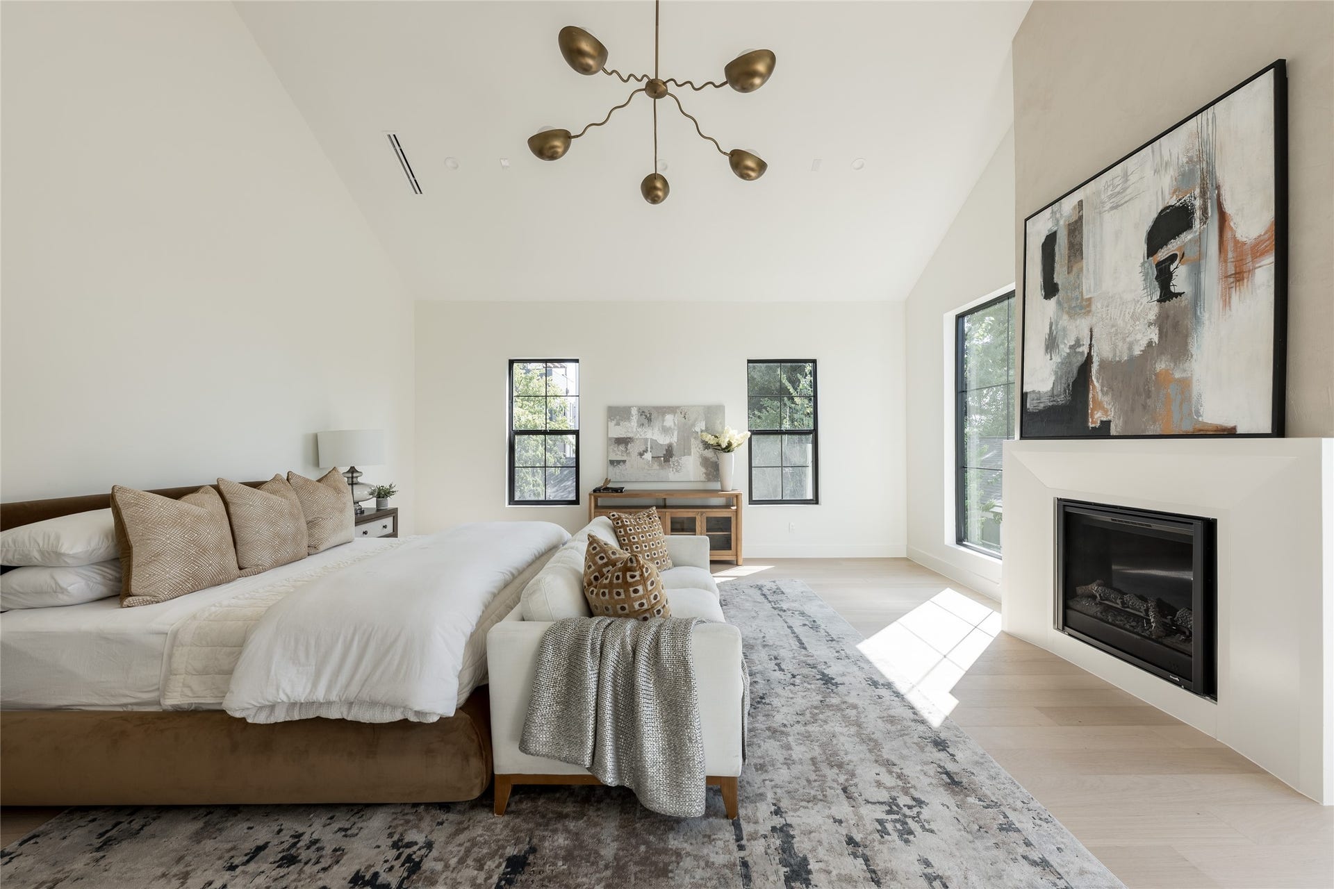 1109 Voight Street, Houston, TX 77009 The expansive primary suite is defined by a soaring cathedral ceiling and fireplace, with enough scale to create a separate sitting area without compromising the sense of retreat.
