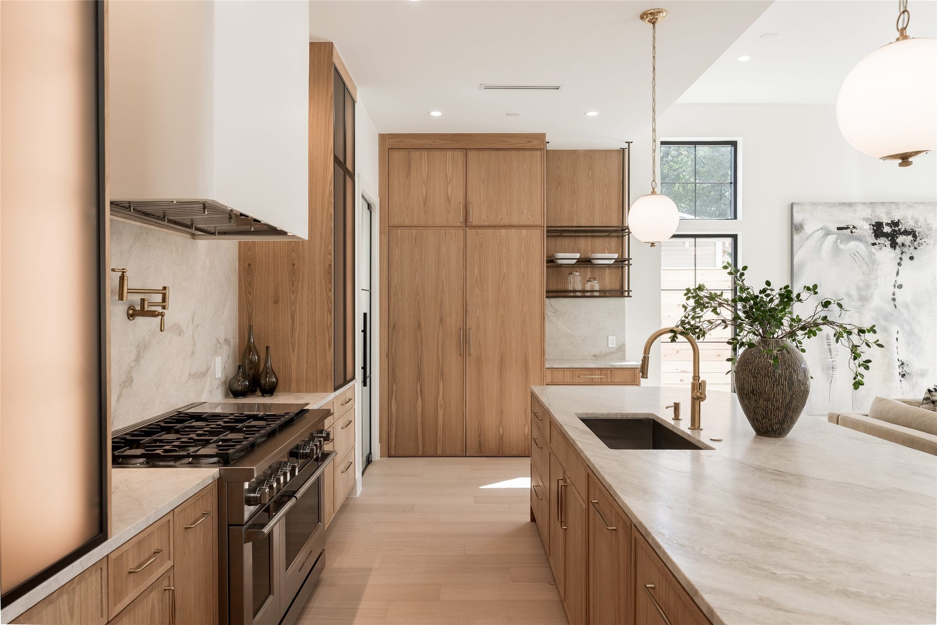 1109 Voight Street, Houston, TX 77009 The chefs kitchen pairs custom white oak cabinetry with natural stone surfaces, while panel ready Fisher & Paykel refrigerator and freezer columns disappear seamlessly into the cabinetry.