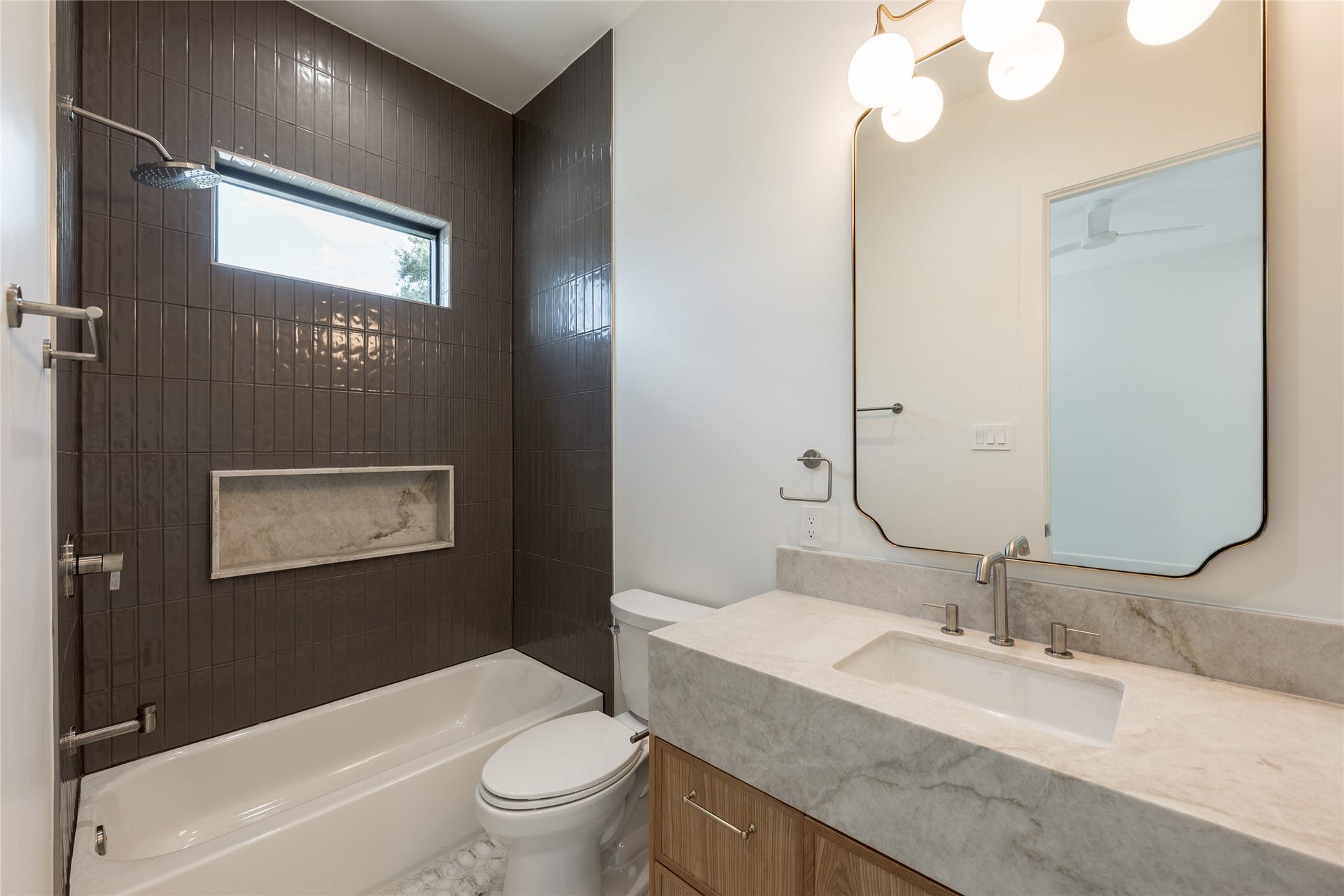 1109 Voight Street, Houston, TX 77009 The secondary ensuite continues the homes refined finish palette with natural stone surfaces, designer tile and a glass enclosed tub and shower, giving guests a private bath of their own.