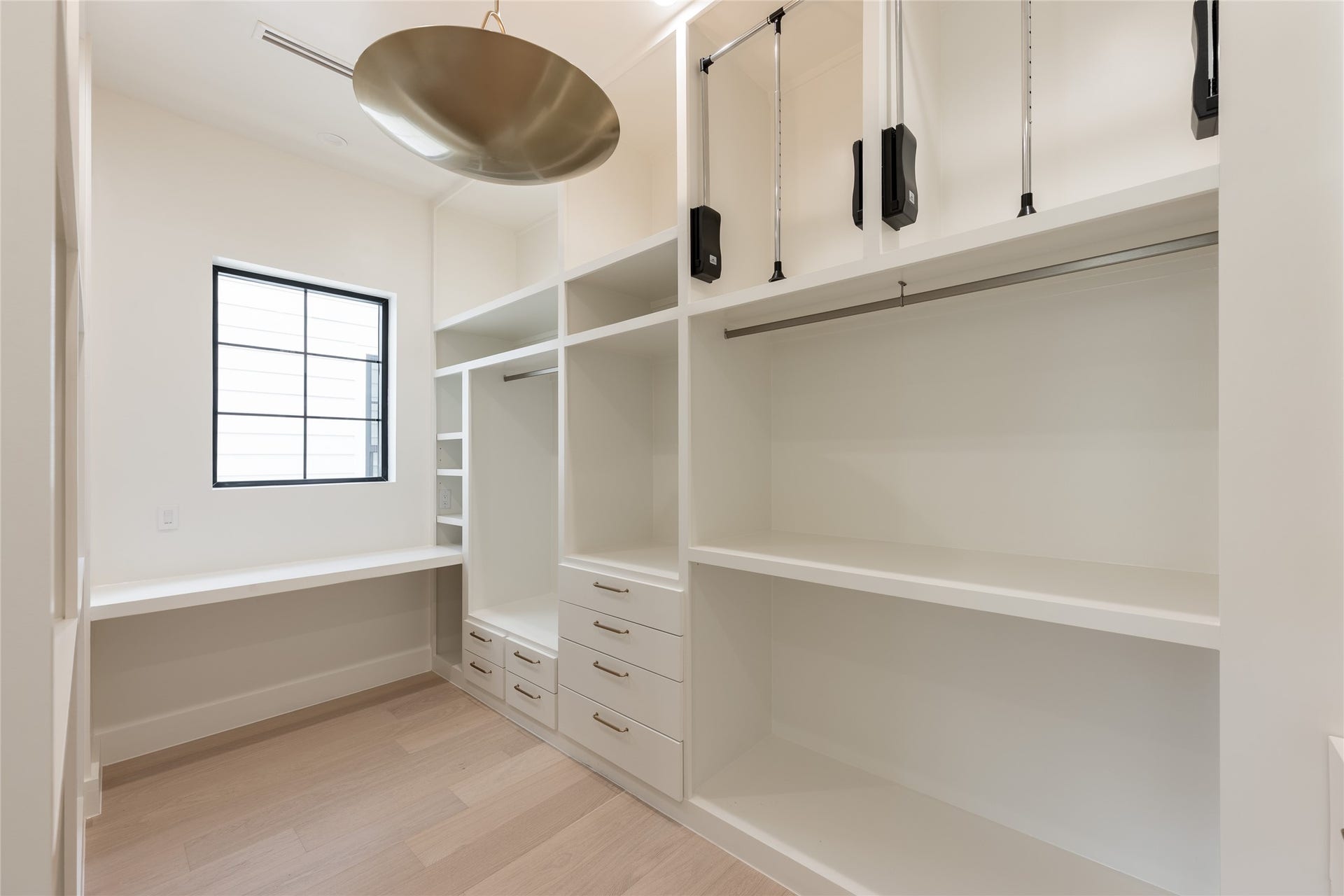 1109 Voight Street, Houston, TX 77009 A second view of the primary closet highlights the generous proportions, with extensive custom shelving, hanging space and natural light creating a dressing area that feels open rather than simply utilitarian.