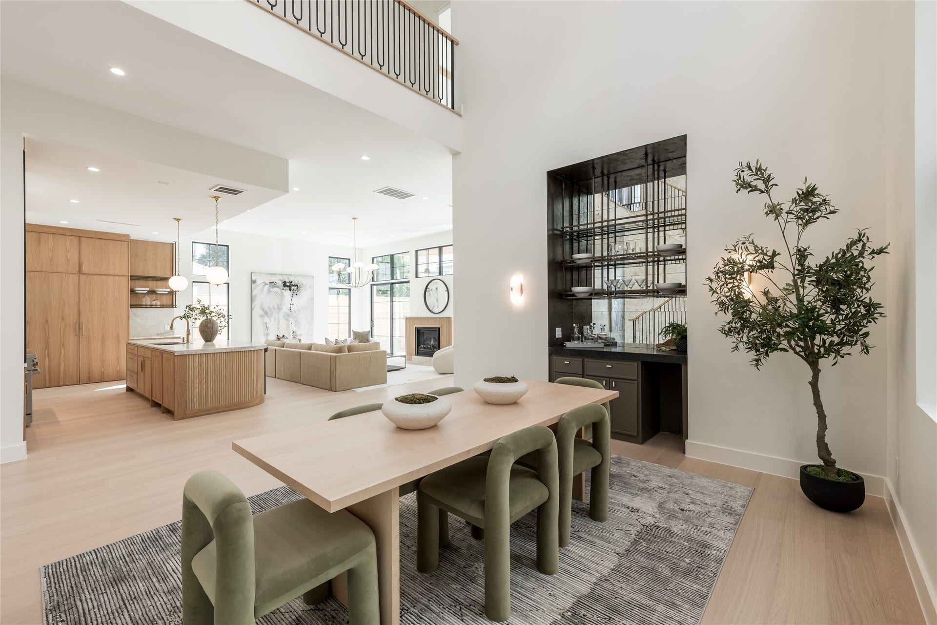 1109 Voight Street, Houston, TX 77009 From the dining room, the homes open architecture comes into full view, connecting the two story volume to the chefs kitchen and great room while the custom white oak staircase adds a sculptural element of its own.